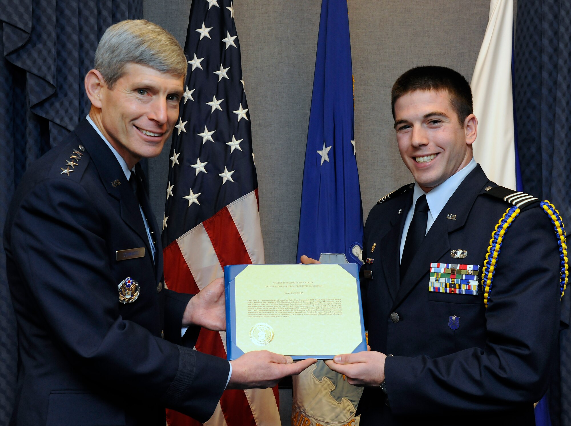 Air Force Chief of Staff Gen. Norton Schwartz presents Cadet Col. Ryan W. Castonia the citation accompanying his U.S. Air Force Cadet of the Year award for 2009 in the Pentagon April 5, 2010.  Cadet Castonia is a graduate student at Massachusetts Institute of Technology and a member of MIT's Reserve Officer Training Corps.  He also was honored by the Air Squadron, a private British aviation organization which has spnsored the award since 2000, and received the Air Squadron's coin from Air Commodore Ian Elliot, a Royal Air Force attache' assigned to the British Embassy in Washington.  (U.S. Air Force photo/Scott M. Ash)