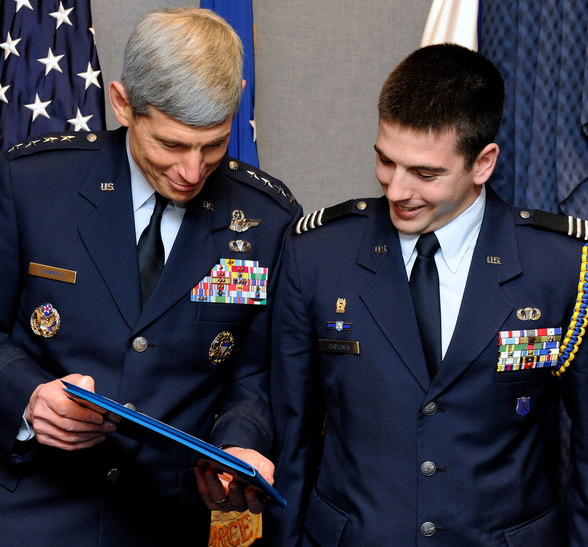 Air Force Chief of Staff Gen. Norton Schwartz shows Cadet Col. Ryan W. Castonia the citation accompanying his U.S. Air Force Cadet of the Year award for 2009 in the Pentagon April 5, 2010.  Cadet Castonia is a graduate student at Massachusetts Institute of Technology and a member of MIT's Reserve Officer Training Corps.  (U.S. Air Force photo/Scott M. Ash)
