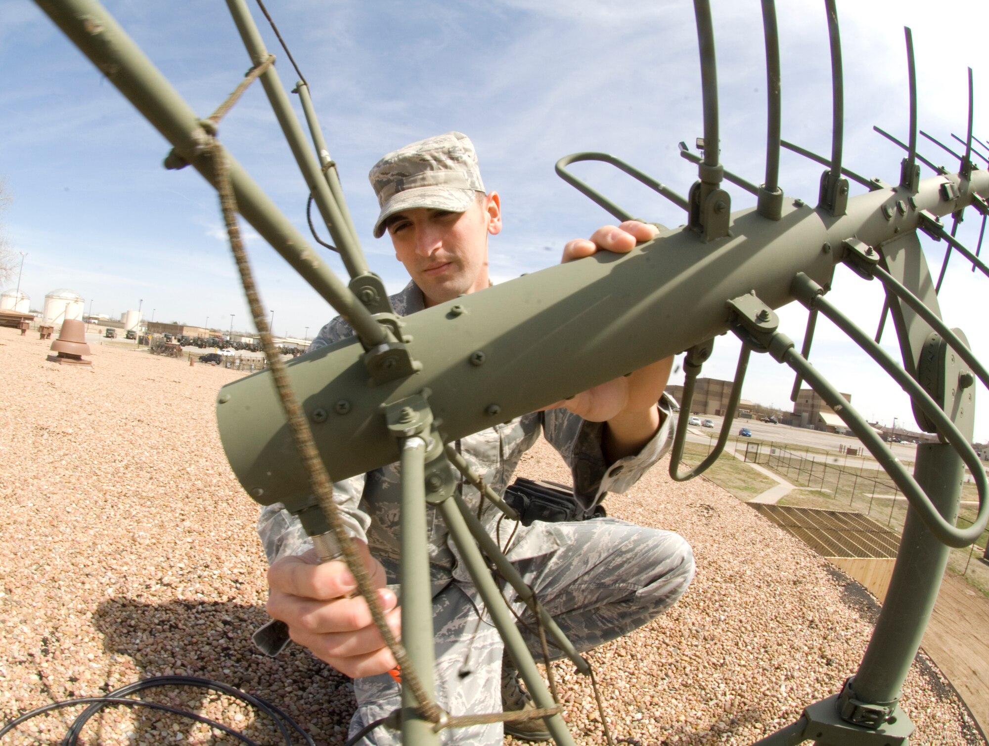 Staff Sgt. James Gumbs, 22nd Operations Group KC-135 special operations air refueling communications assistant NCOIC, positions a high gain satellite communications antenna as a part of an exercise. The Middleburg, Fla., native is also responsible for establishing and troubleshooting secure communications for McConnell’s SOAR missions. (U.S. Air Force photo/Senior Airman Abigail Klein)