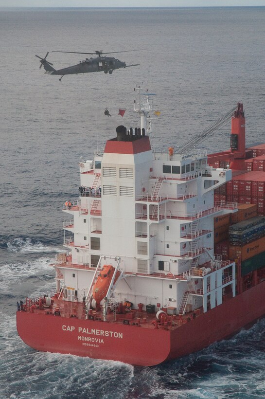 A 129th Rescue Wing HH-60G Pave Hawk rescue helicopter crew hoists a 129th pararescueman during a rescue mission 650 miles off the coast of Baja, Mexico, April 4, 2010. The 129th sent two HH-60G Pave Hawk rescue helicopters and one MC-130P Combat Shadow aircraft, accompanied by one Marine Corps KC-130J Super Hercules tanker from Marine Corps Air Station Miramar, to pick up Michael Kalahar, a 56-year-old sailor from Port Angeles, Wash., who suffered life-threatening head and neck injuries aboard his sailing vessel WIND CHILD. The 129th rescue aircraft also recovered a four-man pararescue team, also based with the 129th. (Photo courtesy of Maj. Mathewe Wenthe)