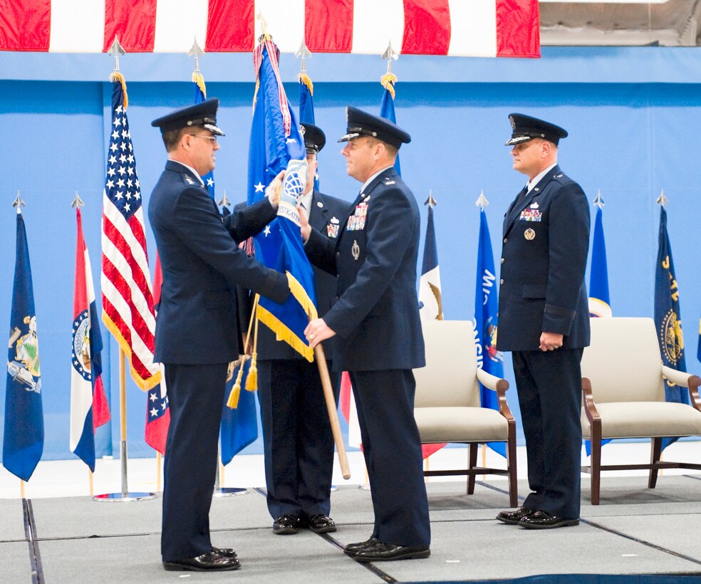 ANDREWS AIR FORCE BASE, Md. -- Lieutenant General Marc E. Rodgers, Inspector General of the Air Force, passes  the Air Force Office of Special Investigations guidon to the incoming AFOSI commander, Col. Kevin J. Jacobsen, who assumed command of the field operating agency, April 6. (U.S. Air Force photo/Mike Hastings)