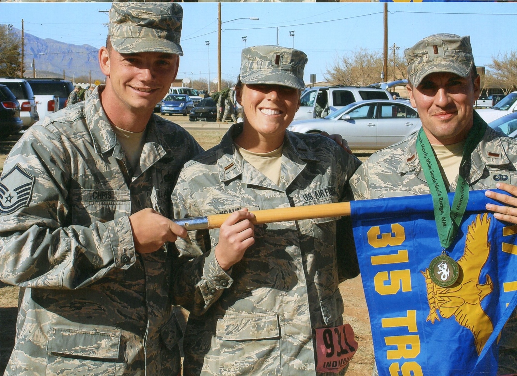 (From left) Master Sgt. Brian Chris,  315th Training Squadron, Fundamentals Team Intelligence Officer Course section chief, 2nd Lieutenant Lindsay Krahn and 2nd Lieutenant Roman Lopez, both 315 TRS Intelligence Officer Course students, pose with their squadrons guideon, March 21, at the Bataan Memorial Death March, White Sands Missile Range, N.M. (U.S. Air Force photo )




