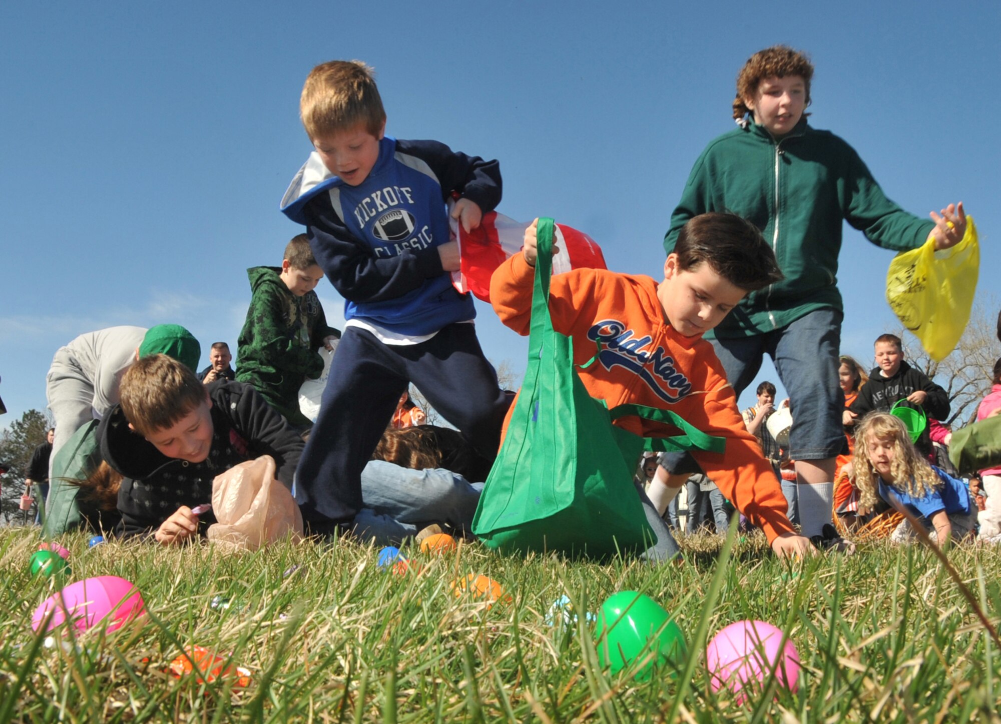 OFFUTT AIR FORCE BASE, Neb. -- Many children from the Offutt community rush and stumble to find their favorite eggs at Offutt's annual Easter egg hunt at the Base Lake April 3. The event was one of several military families took part in during the holiday weekend. U.S. Air Force Photo by Jeff W. Gates