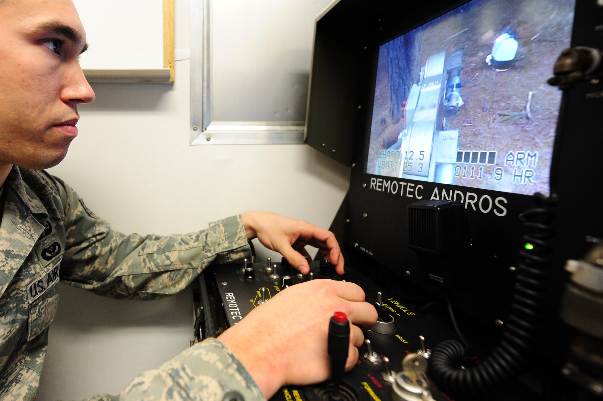 Senior Airman Chris Parillo, 19th Civil Engineer Squadron explosive ordnance disposal journeyman, operates a robot from several hundred feet away during an exercise March 18 on base. EOD Airmen are trained with the safest and smartest tools to get the job done correctly when tasked to deploy to hostile locations. (U.S. Air Force photo by Senior Airman Steele C. G. Britton)