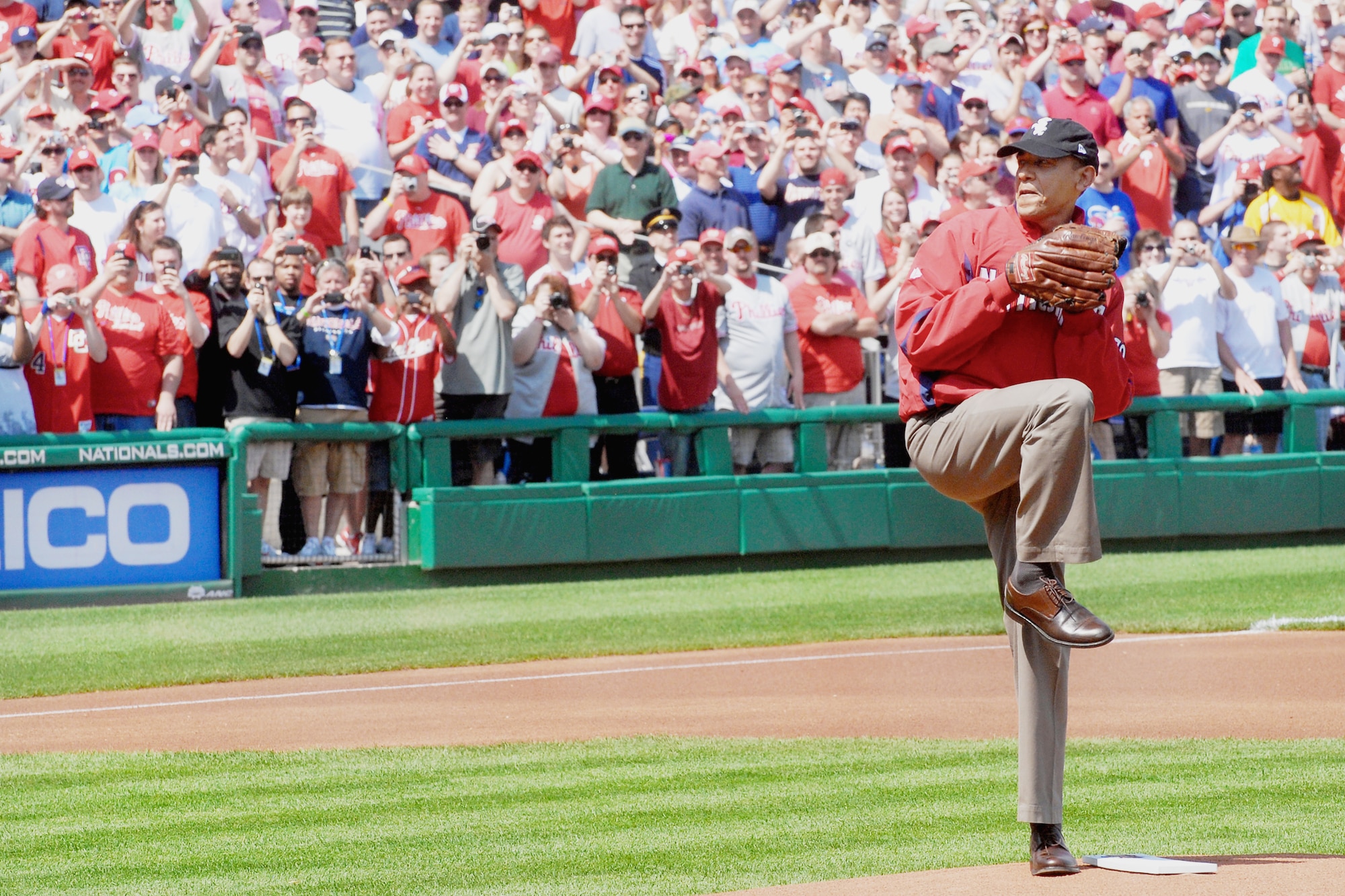President Barack Obama throws out the ceremonial first pitch to start the baseball season for the Washington Nationals April 5, 2010, at Nationals Ball Park in Washington, D.C. The Washington Nationals honored military children, inviting nine children whose parents are deployed to step onto the infield with the starting players to see the president throw out the first pitch. (DOD photo/Navy Petty Officer 2nd Class William Selby) 
