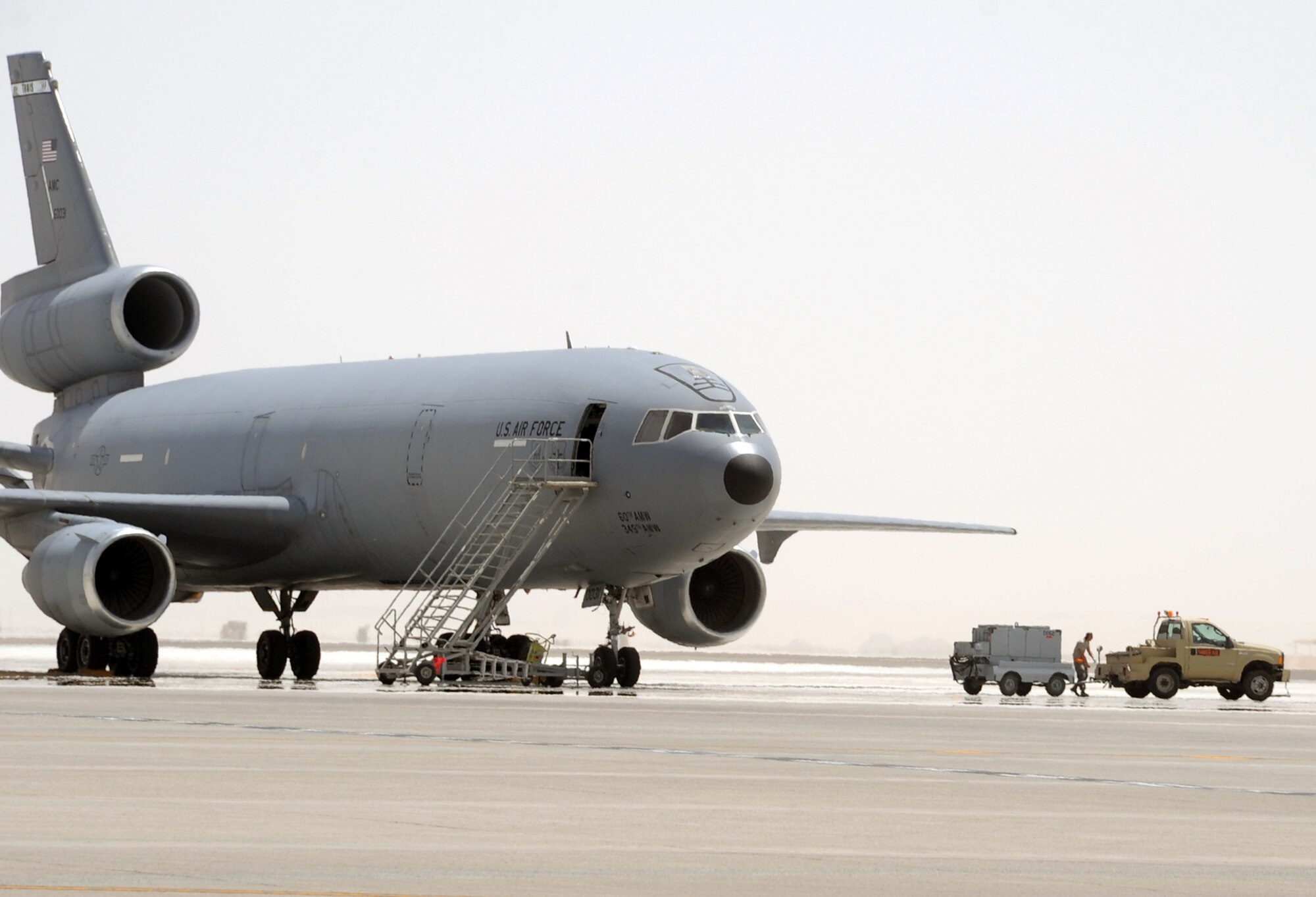 A maintenance Airman with the 380th Expeditionary Maintenance Squadron prepares to connect a generator to a KC-10 Extender during maintenance operations at a non-disclosed base in Southwest Asia on April 2, 2010. The KC-10 is assigned to the 908th Expeditionary Air Refueling Squadron of the 380th Air Expeditionary Wing. The 380th EMXS and the 908th EARS, as part of the 380th AEW, support operations Iraqi Freedom and Enduring Freedom and the Combined Joint Task Force-Horn of Africa. (U.S. Air Force Photo/Master Sgt. Scott T. Sturkol/Released)