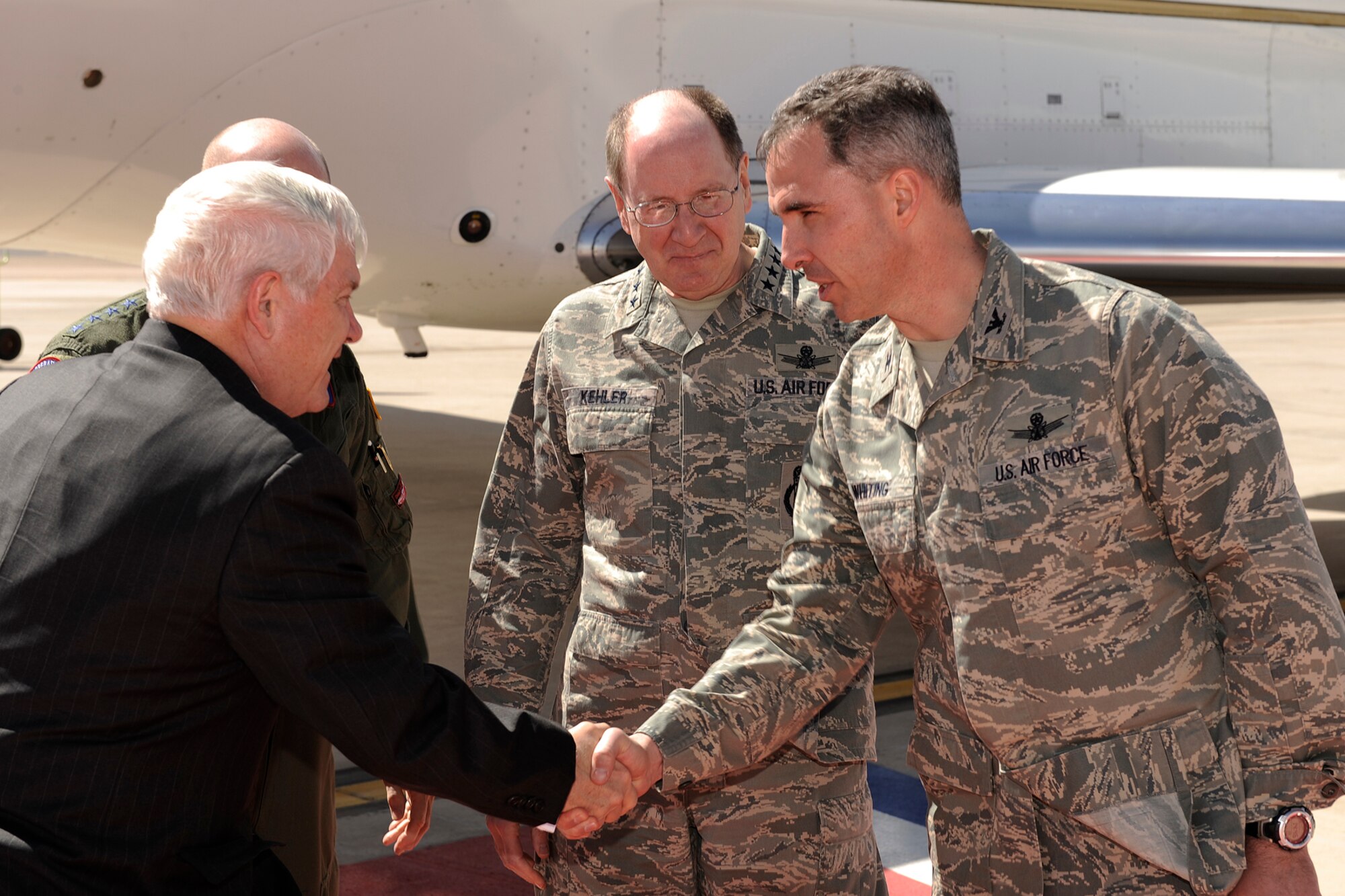 PETERSON AIR FORCE BASE, Colo. -- Secretary of Defense Dr. Robert M. Gates is greeted by Col. Stephen N. Whiting (right), 21st Space Wing commander, and Gen. C. Robert Kehler, Air Force Space Command commander, on the Peterson flightline April 1.  Secretary Gates made a brief stop at Peterson while traveling to the U.S. Air Force Academy. Secretary Gates is the Nation’s 22nd secretary of defense and has served in this position since Dec. 18, 2006. He is the only secretary of defense in U.S. history to be asked to remain in that office by a newly elected president. (U.S. Air Force photo/Craig Denton)