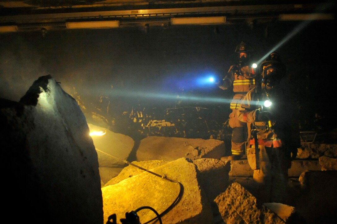 Airman 1st Class Christopher Hale (left) and Senior Airman Kenneth Mize, members of the Air Force District of Washington chemical, biological, radiological, nuclear, and high yield explosives, or CBRNE, response force, search for victims in the "rubble room" during a training scenario at the Center for National Response in Gallagher, W.Va., March 24, 2010. The team is made up of personnel from the 316th Wing, the 79th Medical Wing, and the 11th Wing and is a force that combines the bioenvironmental engineers, civil engineer readiness, emergency management and fire fighters to respond to emergency situations in the National Capital Region. (U.S. Air Force photo by Staff Sgt. Renae L. Saylock)