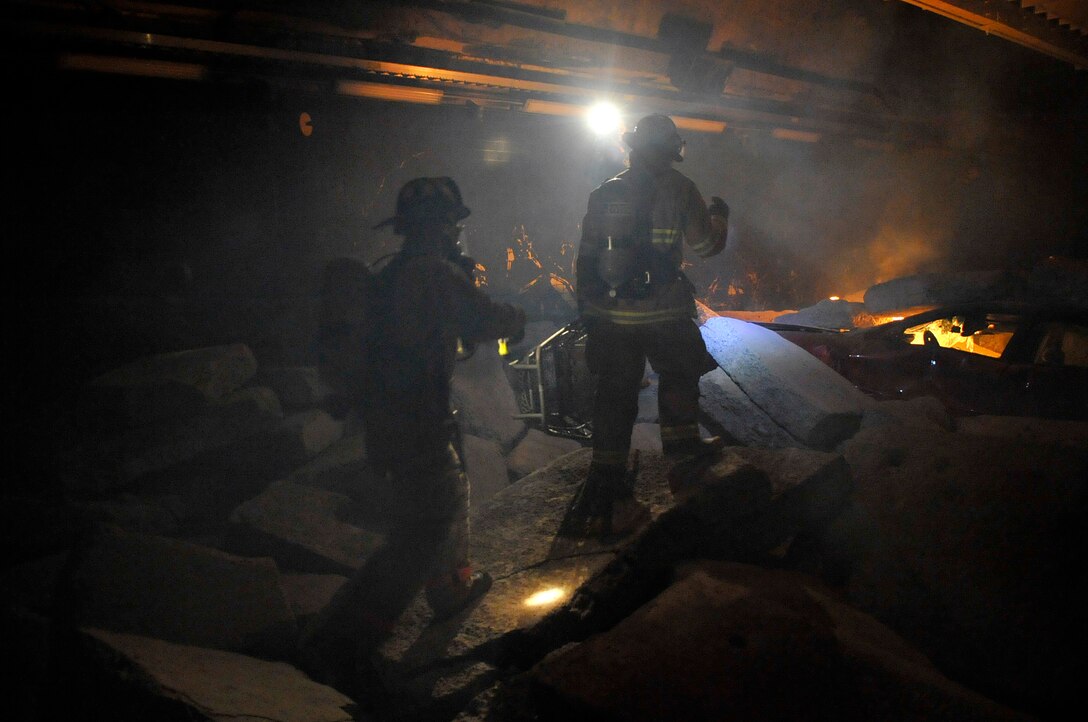 Airman 1st Class Christopher Hale (left) and Senior Airman Kenneth Mize, members of the Air Force District of Washington chemical, biological, radiological, nuclear, and high yield explosives, or CBRNE, response force, search for victims in the "rubble room" during a training scenario at the Center for National Response in Gallagher, W.Va., March 24, 2010. The team is made up of personnel from the 316th Wing, the 79th Medical Wing, and the 11th Wing and is a force that combines the bioenvironmental engineers, civil engineer readiness, emergency management and fire fighters to respond to emergency situations in the National Capital Region. (U.S. Air Force photo by Staff Sgt. Renae L. Saylock)