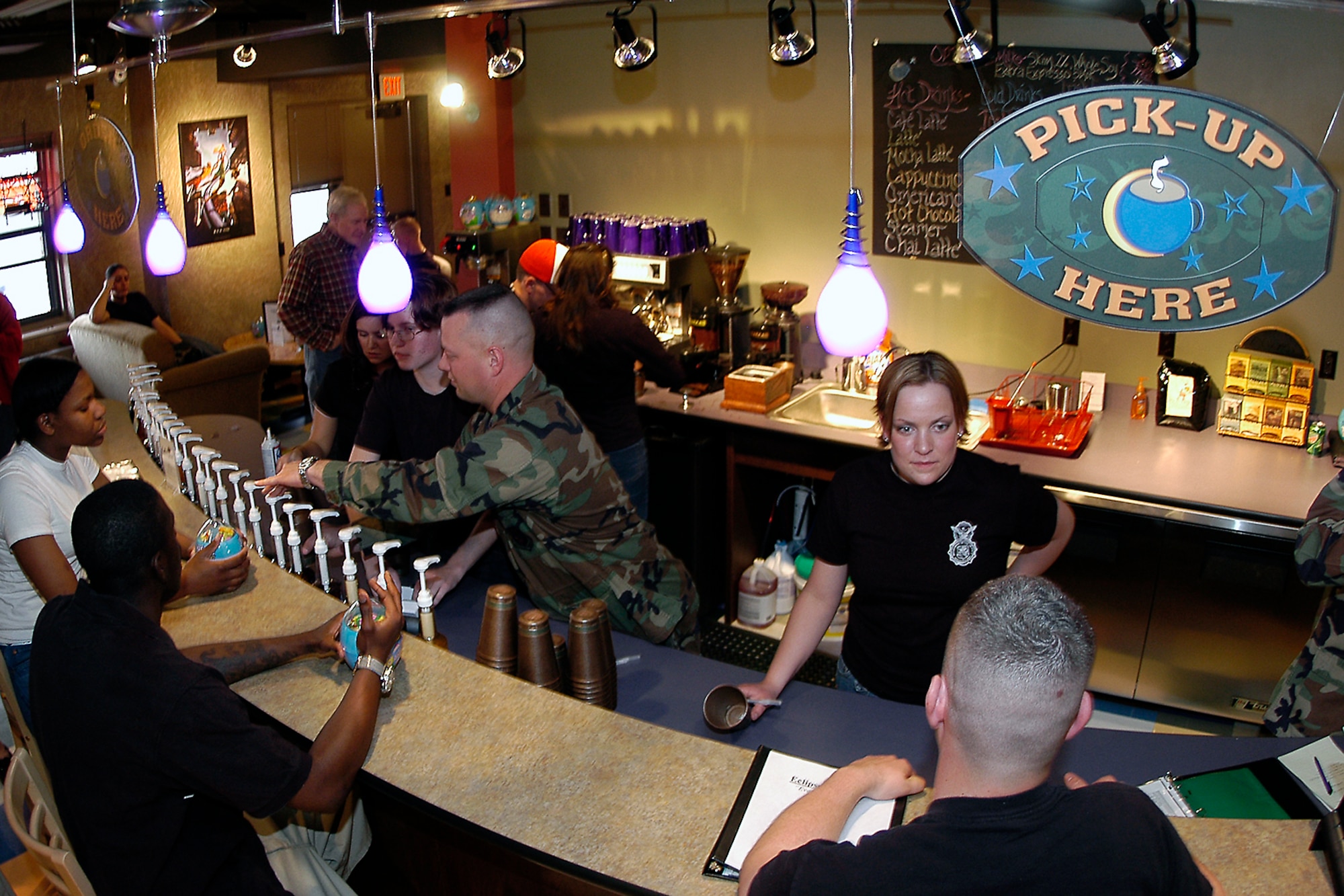 Volunteer Airmen assist Eclipse Cyber Café customers with coffee and other refreshments. The cyber café is located in the Peterson dormitory complex, Building 1164, and provides a safe, positive place for Airmen to relax and enjoy chapel-sponsored refreshments and free Internet access. The café saw a 15 percent increase in use in 2009 over the previous year and has been named the “best in the command.” The 21st Space Wing chapel team recently was named best in the Air Force with the Terence P. Finnegan Award for medium-size chapels. (U.S. Air Force photo/Rob Bussard)