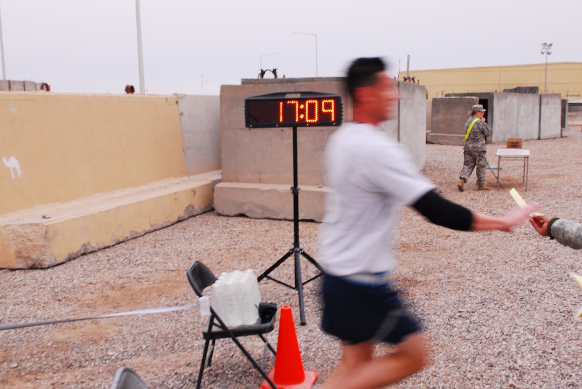 CONTINGENCY OPERATING BASE BASRA, Iraq -- Air Force Capt. Brandon R. Bryan, 1st Logistics Readiness Squadron out of Langley Air Force Base, Va., blurs by the competition to take first place overall in this year’s Molly Pitcher 5K run held March 21. (U.S. Army photo/Spc. Maurice A. Galloway)
