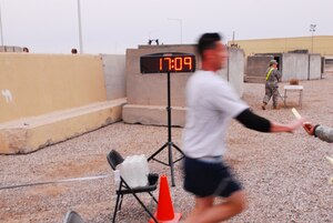 CONTINGENCY OPERATING BASE BASRA, Iraq -- Air Force Capt. Brandon R. Bryan, 1st Logistics Readiness Squadron out of Langley Air Force Base, Va., blurs by the competition to take first place overall in this year’s Molly Pitcher 5K run held March 21. (U.S. Army photo/Spc. Maurice A. Galloway)
