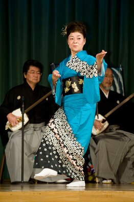 MISAWA AIR BASE, Japan -- A Japanese woman performs a folk dance accompanied by shamisen music during the 23rd Annual Japan Day April 3 at the Collocated Club. The shamisen is a three-stringed fretless lute common in Japanese folk music with a sound similar to a banjo. The Tsugaru shamisen used in the performance is unique to northern Japan with a longer neck for a deeper sound. (U.S. Air Force photo/Staff Sgt. Samuel Morse)