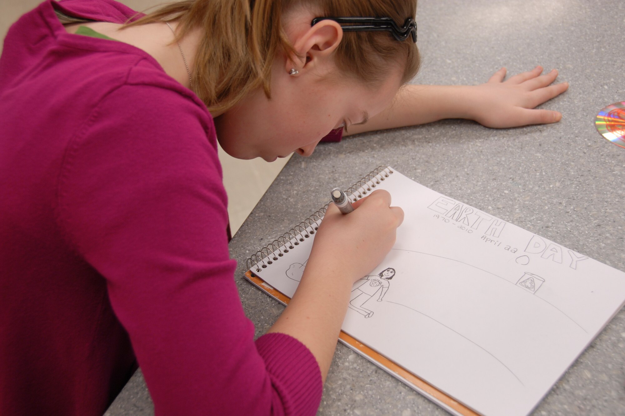 Danielle Benedict, a sixth-grader at Osan Middle School, works on an Earth Day poster during art class April 6. The 51st Civil Engineer Squadron is sponsoring an Earth Day poster contest, open to all elementary, middle and high school students at Osan Air Base, Republic of Korea. Posters must be hand-created drawings – no computer-generated images are eligible – and entries should be submitted no later than April 19. For more information, e-mail 51CES.Environmental@osan.af.mil. (U.S. Air Force photo/Staff Sgt. Eric Burks)