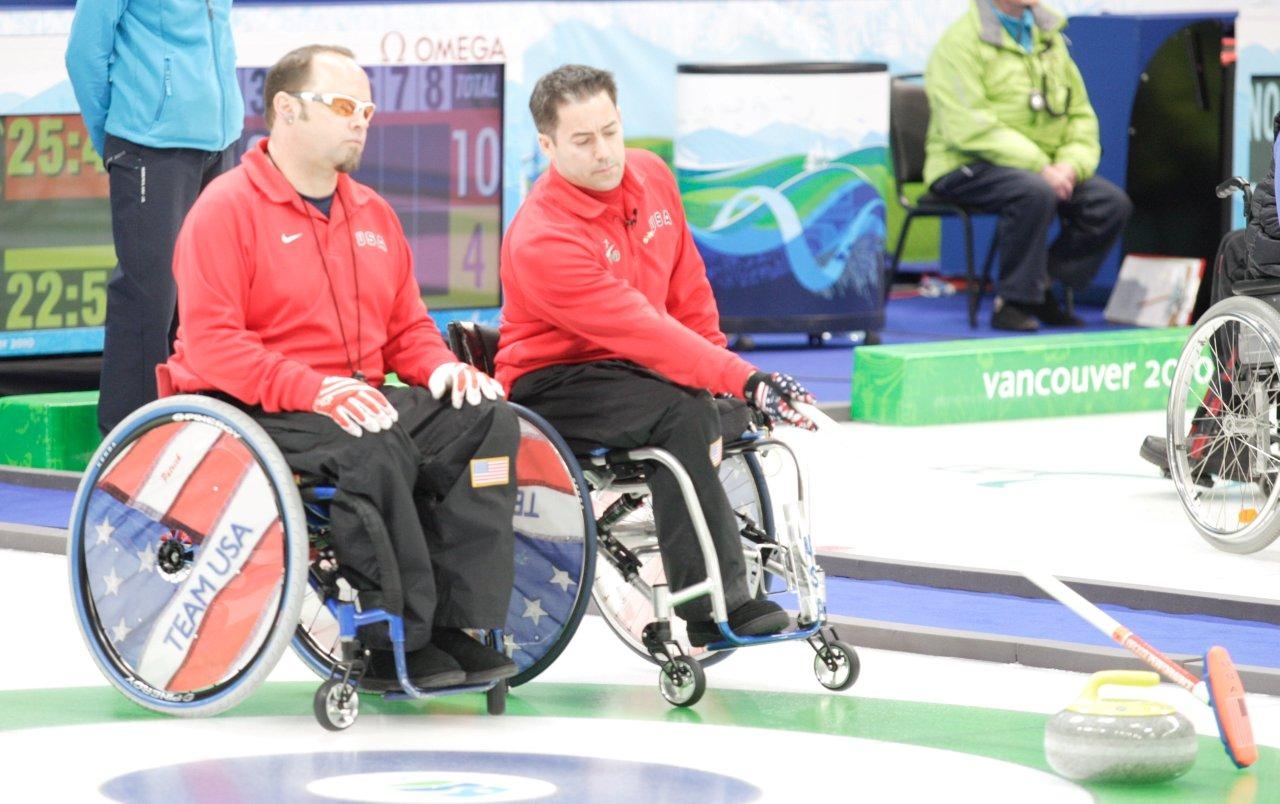 Army veteran Patrick McDonald talks strategy with a teammate during a