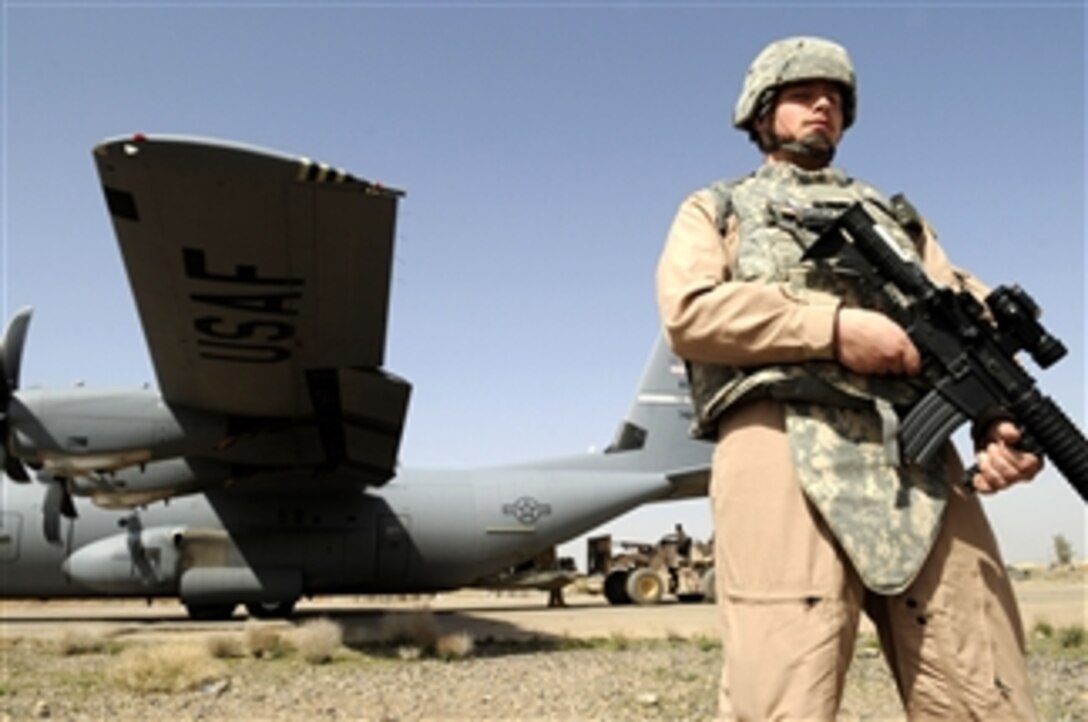 U.S. Air Force Senior Airman Edward Roberts, a fly away security team member from the 451st Expeditionary Security Forces Squadron, provides ground security for a C-130J Hercules cargo aircraft in Shindand, Afghanistan, on March 12, 2010.  Roberts is assigned to the 49th Security Forces Squadron at Holloman Air Force Base, N.M.  