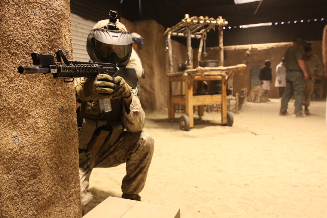 Marines with Weapons Company, 1st Battalion, 1st Marine Regiment, 1st Marine Division, conduct security techniques inside Camp Pendleton’s Infantry Immersion Trainer, April 7. The 32,000-square-foot military urban training facility was recently changed from a simulated Iraqi village, to resemble the Afghan village of Now Zad, after the Headquarters Marine Corps officials made the decision March 15, to modify the training environment.