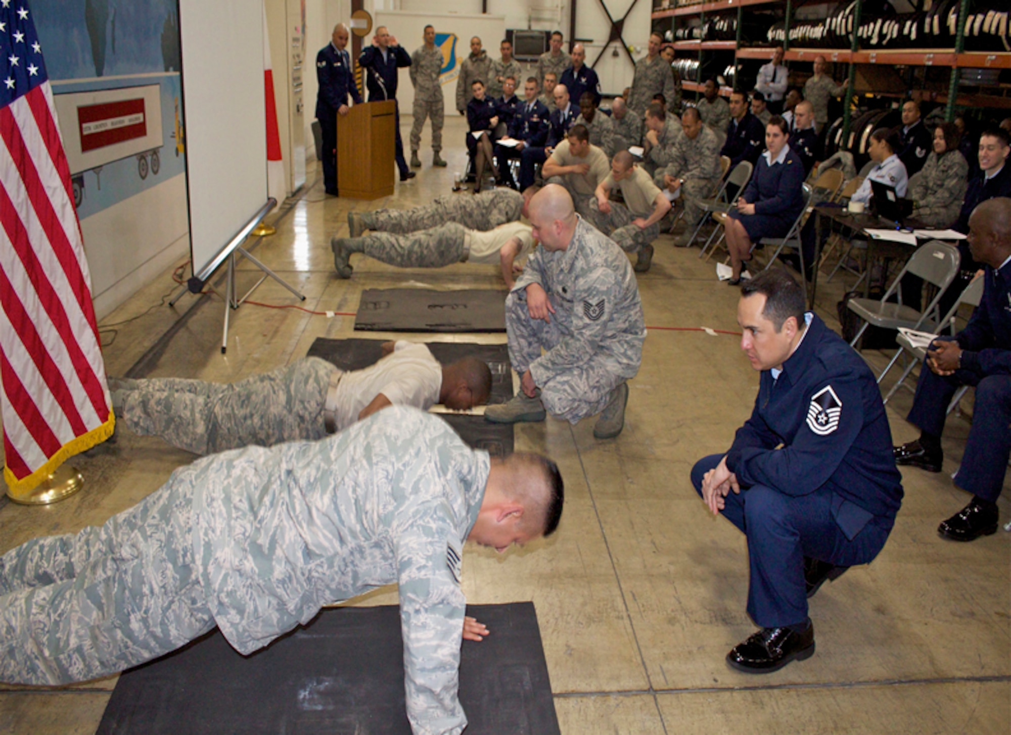 MISAWA AIR BASE, Japan -- Flight representatives from the 35th Logistics Readiness Squadron compete in a pushup competition during a monthly 35th LRS Warrior Challenge March 29. The Warrior Challenge consisted of pushups, sit-ups and Air Force knowledge sections. The challenge was created to encourage flight camaraderie and pride while reminding all Airmen in the squadron of the importance of physical fitness and warrior knowledge. The Material Management Flight won the competition and now holds the Warrior Challenge trophy for April. (U.S. Air Force photo/ Maj. Ian Hester)
