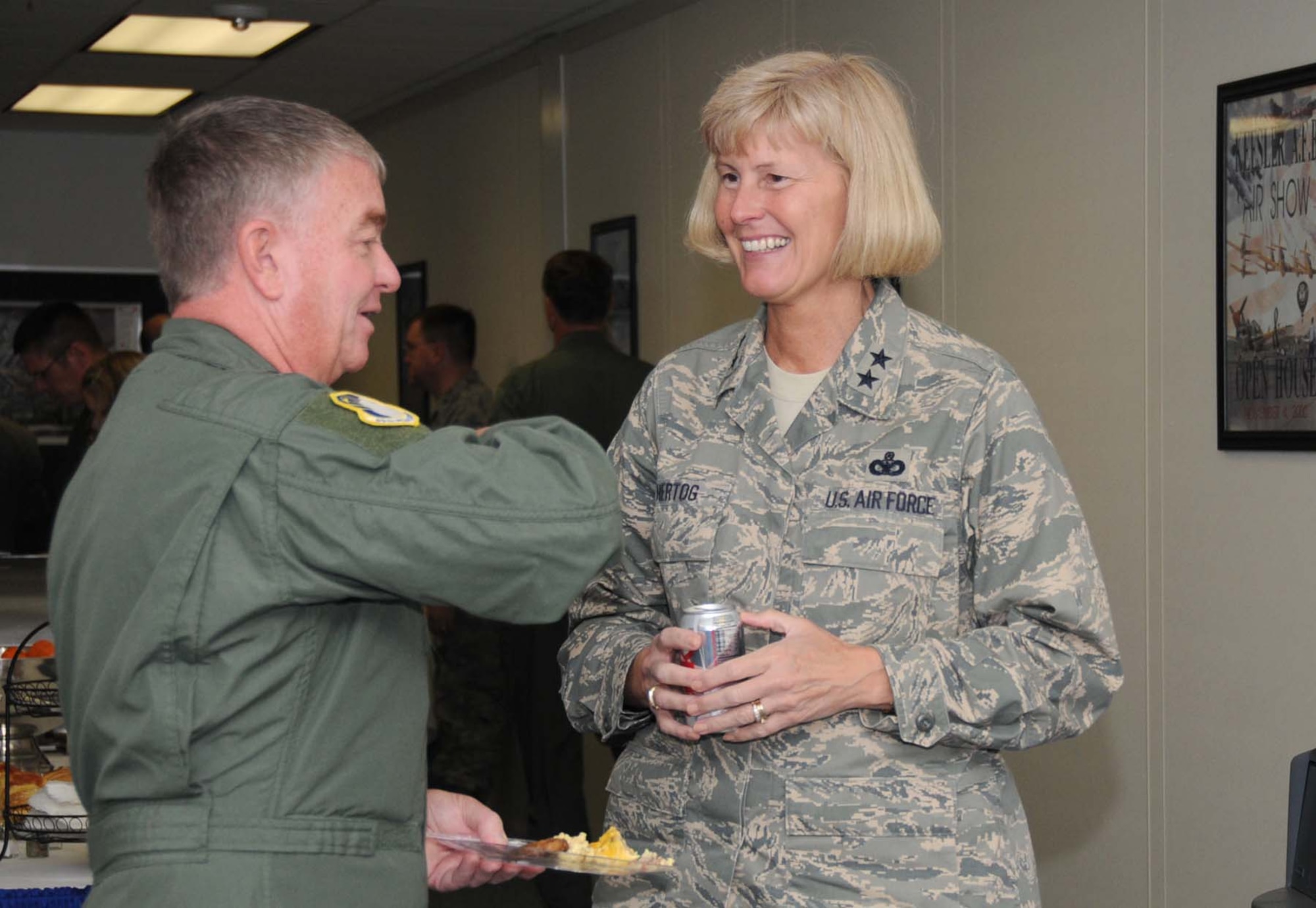 Maj. Gen. Tom Travis, 59th Medical Wing commander, Lackland Air Force Base, Texas, talks to Maj. Gen. Mary Kay Hertog, March 30 at a breakfast during Air Education and Training Command's spring conference for 118 commanders, senior leaders and support staff hosted by Keesler March 29 through April 1.  (U.S. Air Force photo by Kemberly Groue)