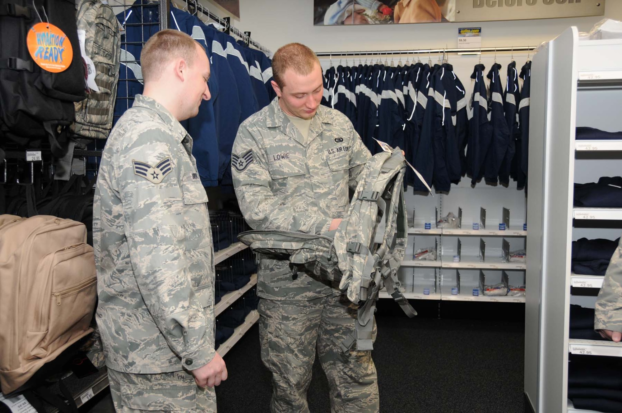 Senior Airman Tom Sirovey, left, and Staff Sgt. Brian Lowie, 81st Training Support Squadron, check out the backpacks at the military clothing exchange.  (U.S. Air Force photo by Kemberly Groue)