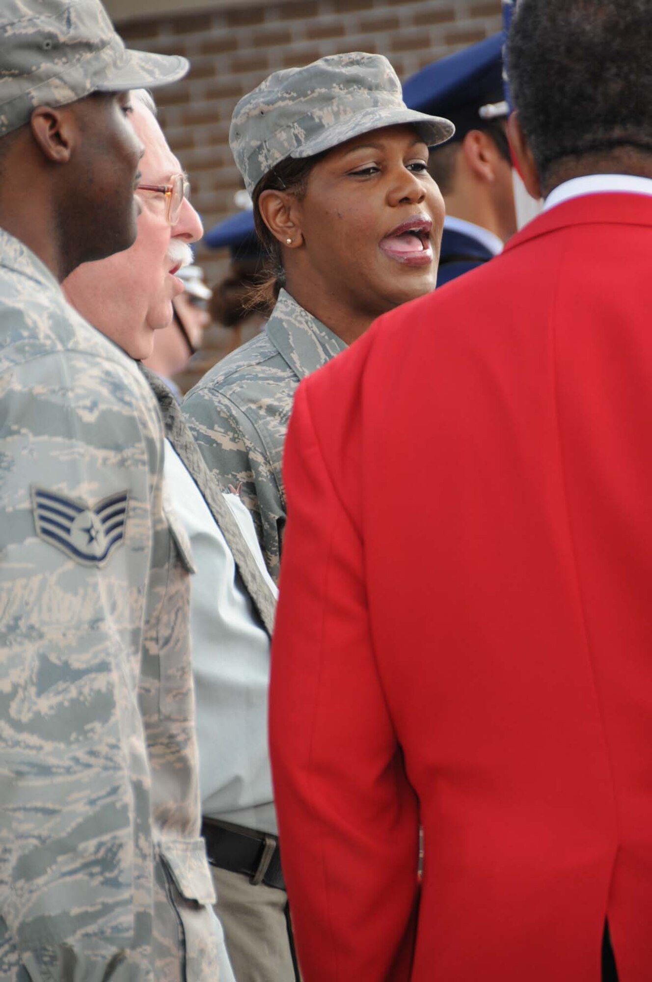 Master Sgt. Hope Skinner, 335th Training Squadron, and other members of the 81st Training Group chorus sing the National Anthem.  (U.S. Air Force photo by Kemberly Groue)