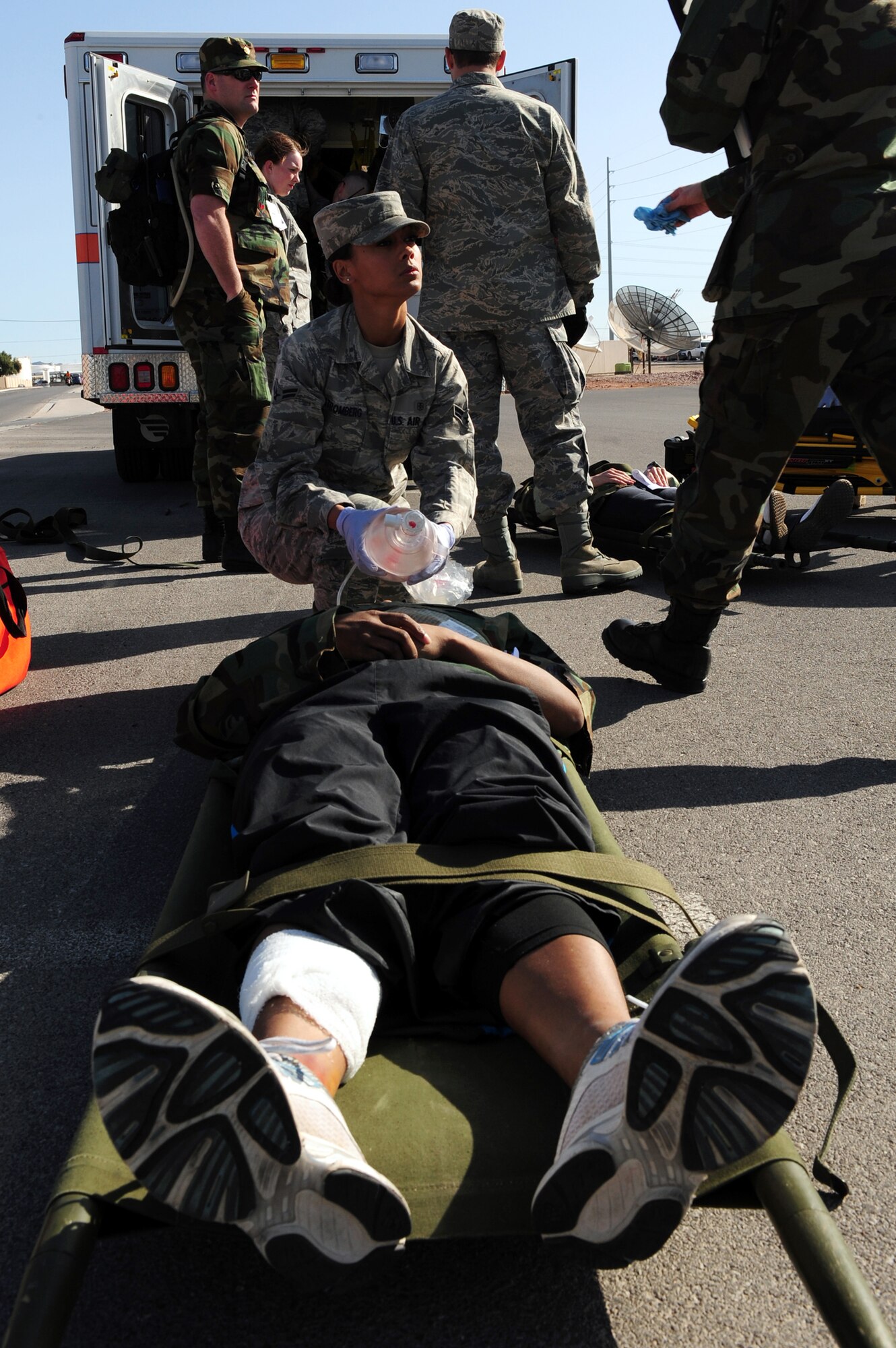 NELLIS AIR FORCE BASE, Nev. -- 
Airman First Class Ulla Stromberg, 99th Medical Group, gives oxygen to a patient during an All Hazardous Response Exercise March 27.  The All Hazard Response Exercise tests the abilities of the 99 MDG, when reacting to a mass casualty scenario.  Airmen had to quickly respond to simulated situations to include bomb blast, fires and hazardous contamination. (U.S. Air Force Photo by Staff Sgt. William P. Coleman/RELEASED)

