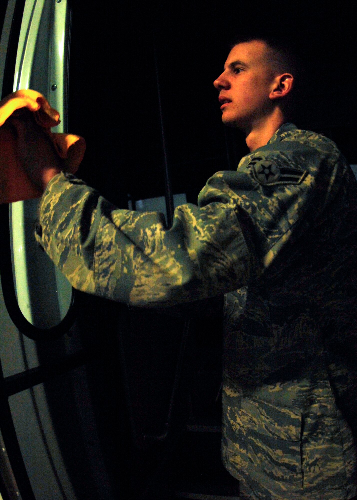 MINOT AIR FORCE BASE, N.D. -- Airman 1st Class Anthony Rosa, 5th Logistics Readiness Squadron vehicle operations vehicle operator, cleans the windows of the shuttle used for Maj. Gen. Floyd Carpenter, 8th Air Force commander. Airman Rosa not only cleans vehicles, but is also expected to become certified in driving various buses and trucks. (U.S. Air Force photo by Airman 1st Class Ashley N. Avecilla)