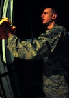 MINOT AIR FORCE BASE, N.D. -- Airman 1st Class Anthony Rosa, 5th Logistics Readiness Squadron vehicle operations vehicle operator, cleans the windows of the shuttle used for Maj. Gen. Floyd Carpenter, 8th Air Force commander. Airman Rosa not only cleans vehicles, but is also expected to become certified in driving various buses and trucks. (U.S. Air Force photo by Airman 1st Class Ashley N. Avecilla)