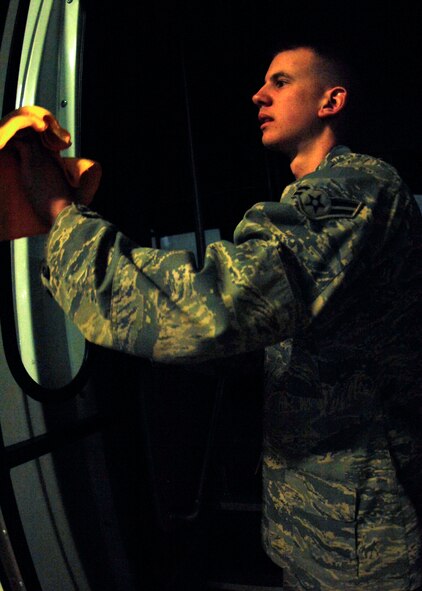 MINOT AIR FORCE BASE, N.D. -- Airman 1st Class Anthony Rosa, 5th Logistics Readiness Squadron vehicle operations vehicle operator, cleans the windows of the shuttle used for Maj. Gen. Floyd Carpenter, 8th Air Force commander. Airman Rosa not only cleans vehicles, but is also expected to become certified in driving various buses and trucks. (U.S. Air Force photo by Airman 1st Class Ashley N. Avecilla)