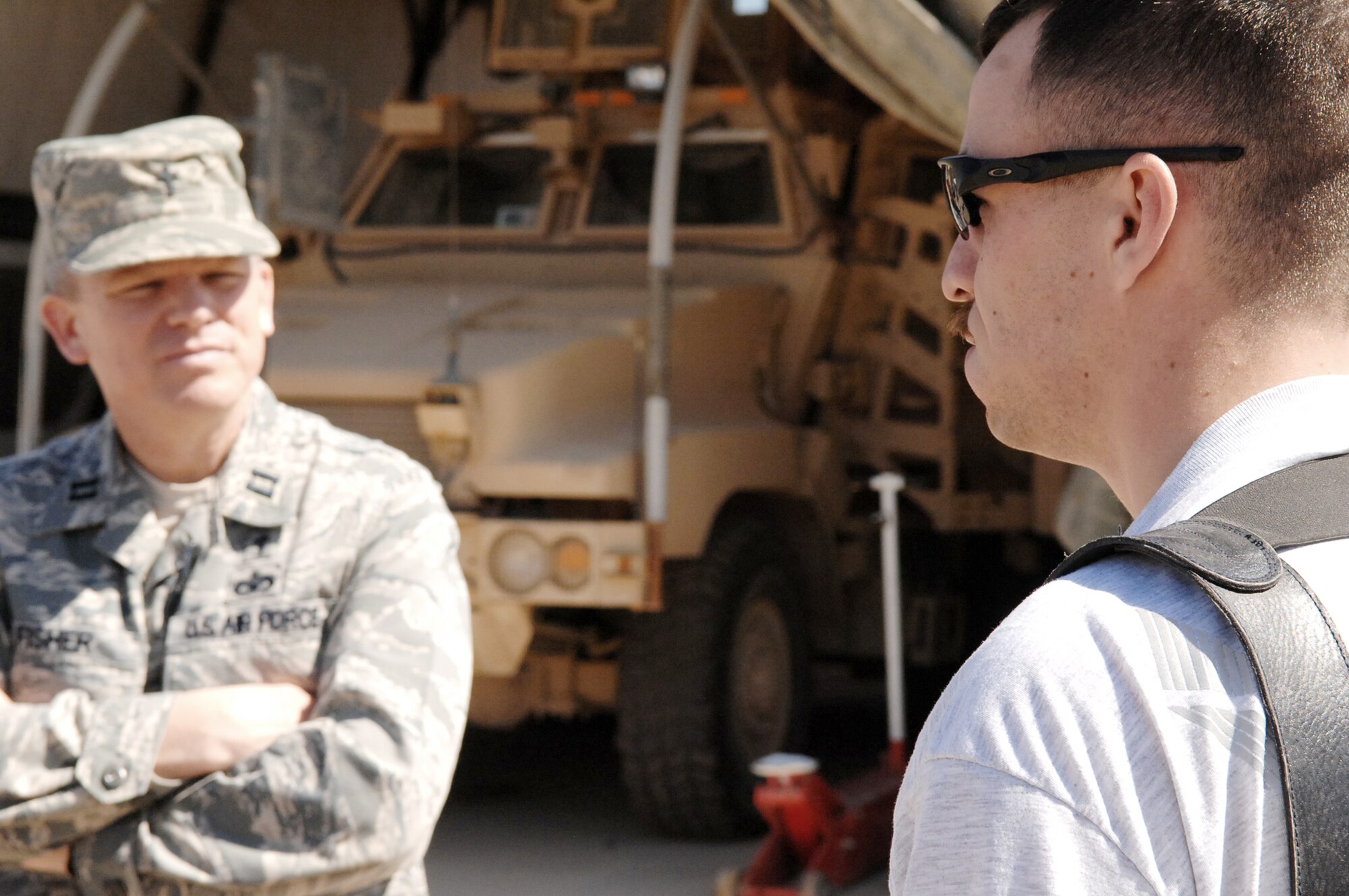 Chaplain (Capt.) Steve Fisher talks with Senior Airman David Kelly March 22, 2010, while on a mission to Camp Stryker, Iraq. Chaplain Fisher is the 732nd Air Expeditionary Group chaplain. Airman Kelly is a 732nd AEG Security Forces Squadron vehicle driver. (U.S. Air Force photo/Airman 1st Class Allison M. Boehm)