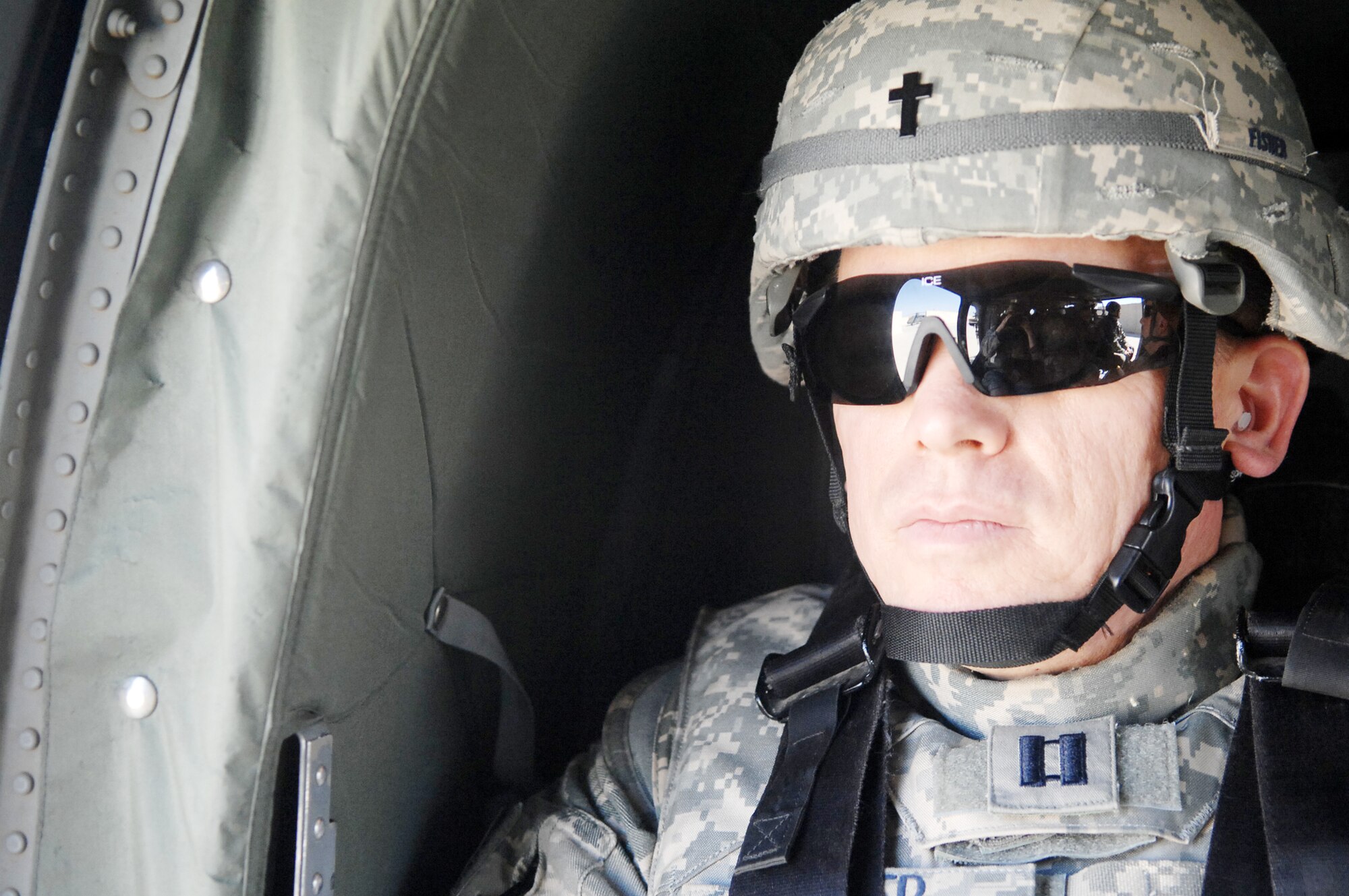 Chaplain (Capt.) Steve Fisher gazes out the window of a UH-60 Blackhawk March 22, 2010, en route to Baghdad International Airport. Chaplain Fisher visited more than 100 Airmen while on his mission to provide pastoral access and care to Airmen at remote locations. Chaplain Fisher is the 732nd Air Expeditionary Group chaplain. (U.S. Air Force photo/Airman 1st Class Allison M. Boehm)