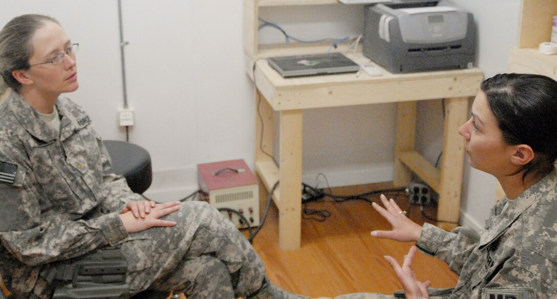Maj. Kim Floyd speaks with Army Spc. Autumn L. Gregg April 1, 2010, at Forward Operating Base Lightning in Afghanistan's Paktia province. Major Floyd is a psychologist assigned to the Combat Stress Control Det. 1. She is deployed from the 92nd Medical Group at Fairchild Air Force Base, Wash. (U.S. Army photo/Sgt. Andrew A. Reagan)