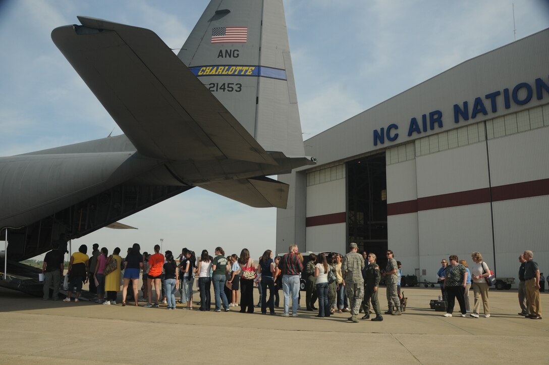 Charlotte, N.C. Several dozen volunteers who will be patients during a National Disaster Medical System  regional exercise wait their turn to board a C-130 Hercules cargo plane. More than two dozen city, state, and federal agencies worked together during the day long exercise at the Charlotte Air Guard base simulating over 100 evacuees arriving for medical care. NCANG Photo by Tech. Sgt. Brian E. Christiansen .