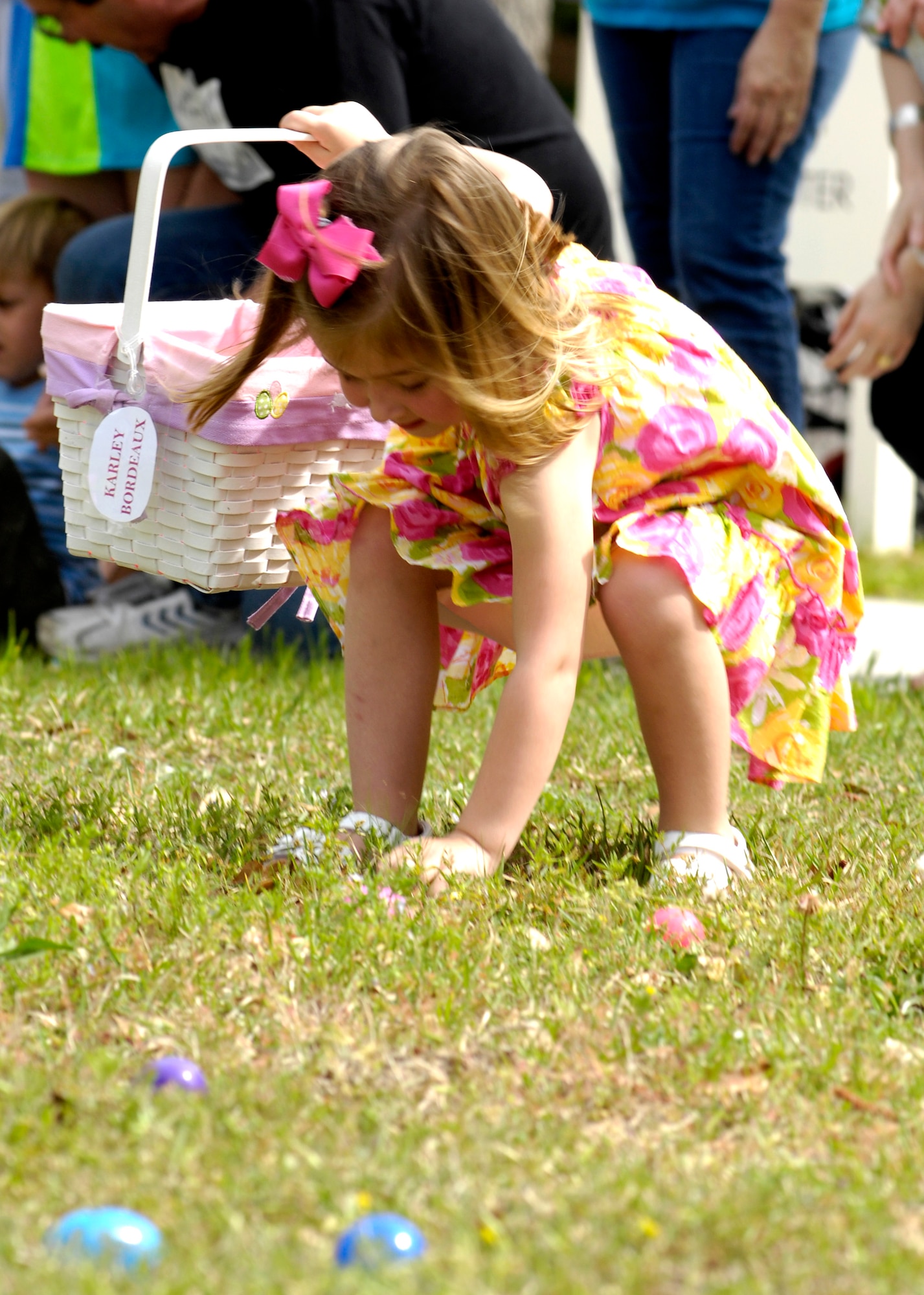 Karley Bordeaux enthusiastically picks up her first egg at the Easter egg hunt on Joint Base Charleston, S.C., April 3, 2010. The hunt, located in the fields behind the commissary, was littered with eggs for each age group. The eggs were filled with candy and coupons for the commissary donated on behalf of JB CHS.  Karley is the daughter of Tech. Sgt. Harold Bordeaux who is a loadmaster with the 17th Airlift Squadron. (U.S. Air Force Photo/Airman 1st Class Lauren Main)