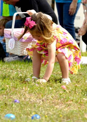 Karley Bordeaux enthusiastically picks up her first egg at the Easter egg hunt on Joint Base Charleston, S.C., April 3, 2010. The hunt, located in the fields behind the commissary, was littered with eggs for each age group. The eggs were filled with candy and coupons for the commissary donated on behalf of JB CHS.  Karley is the daughter of Tech. Sgt. Harold Bordeaux who is a loadmaster with the 17th Airlift Squadron. (U.S. Air Force Photo/Airman 1st Class Lauren Main)