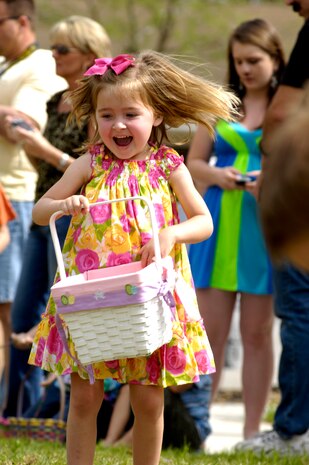 Karley Bordeaux takes off into the field as the horn sounds, marking the beginning of the Easter egg hunt on Joint Base Charleston, S.C., April 3, 2010. The fields were divided into four different sections for the different age groups. There were approximately 3,000 eggs hidden throughout the fields.  Karley is the daughter of Tech. Sgt. Harold Bordeaux who is a loadmaster with the 17th Airlift Squadron. (U.S. Air Force Photo/Airman 1st Class Lauren Main)