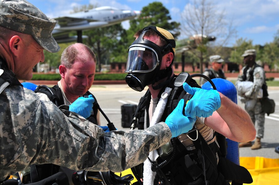 SEYMOUR JOHNSON AIR FORCE BASE, N.C. -- Army Sgt. James Storms has his self-contained breathing apparatus checked by Army Sgt. 1st Class Robert Johnson before removing it during an initial survey of a chemical, biological, radiological and nuclear hazard exercise here, March 30, 2010. Sergeant Johnson checks and records how much air is left in the tank and if it is reusable. Sergeant Storms, a logistics NCO with the 42nd Civil Support Team North Carolina National Guard, is from Clayton. Sergeant Johnson, an information systems NCO with the 42nd CST North Carolina National Guard, hails from Rocky Mount. (U.S. Air Force photo/Senior Airman Rae Perry)