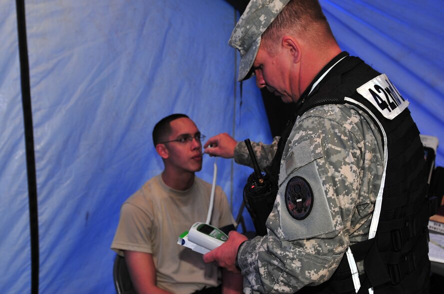 SEYMOUR JOHNSON AIR FORCE BASE, N.C. -- Army Capt. John Wuest checks Army Sgt. Javier Rivera's vital signs after completing an initial site survey of a simulated chemical, biological, radiological and nuclear hazard here, March 30, 2010. Before entering a contaminated zone, each responder must have their vital signs recorded to ensure they are physically capable of donning a suit. Immediately after exiting the hot zone responder's vital signs are checked to ensure they were not contaminated and need no further medical assistance. Captain Wuest a physician assistant with the 42nd Civil Support Team North Carolina National Guard, hails from Greenville. Sergeant Rivera, a surveyor NCO with the 42nd CST North Carolina National Guard, is originally from Fayetteville. (U.S. Air Force photo/Senior Airman Rae Perry)
