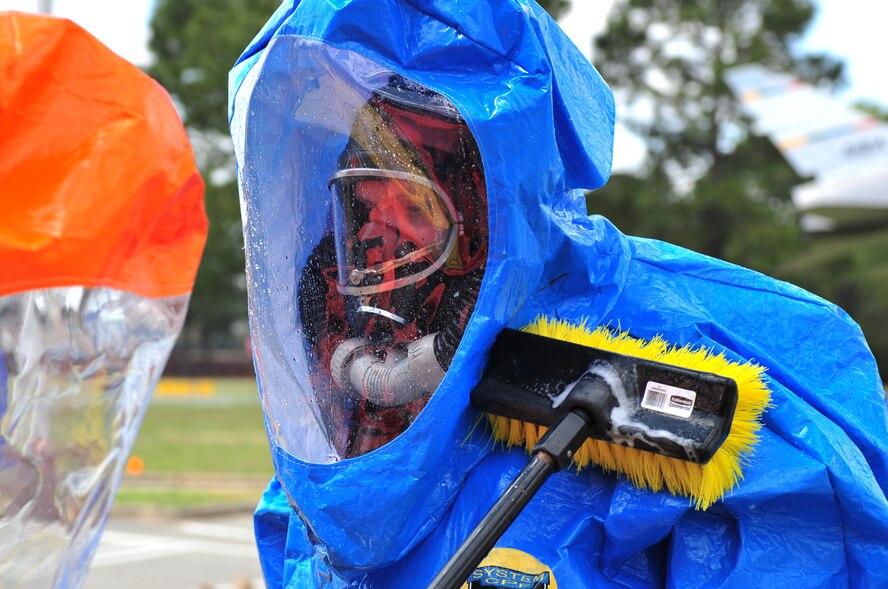 SEYMOUR JOHNSON AIR FORCE BASE, N.C. -- A fellow Soldier scrubs down Army Staff Sgt. Michael Townsend after he responded to a simulated chemical, biological, radiological and nuclear hazard exercise here, March 30, 2010. Sergeant Townsend is part of the 42nd Civil Support Team which is preparing for an external evaluation to test its preparation and response to weapons of mass destruction. Sergeant Townsend, the team's surveyor, hails from Greenville. (U.S. Air Force photo/Senior Airman Rae Perry)