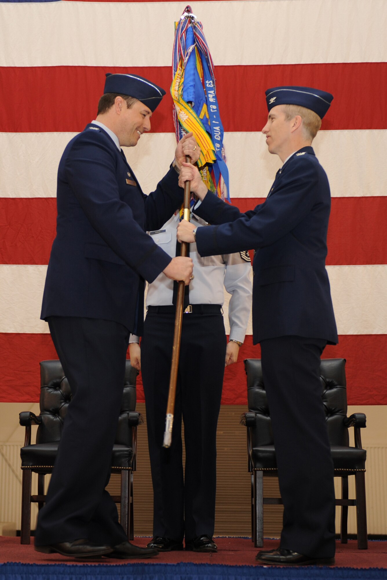 MOUNTAIN HOME AIR FORCE BASE, Idaho -- Col. John Bird, 366th Fighter Wing commander, passes the 366th Mission Support Group guidon to Col. Scott Moser during the assumption of command ceremony April 7 at Hangar 1331. (U.S. Air Force photo by Airman 1st Class Renishia Richardson)