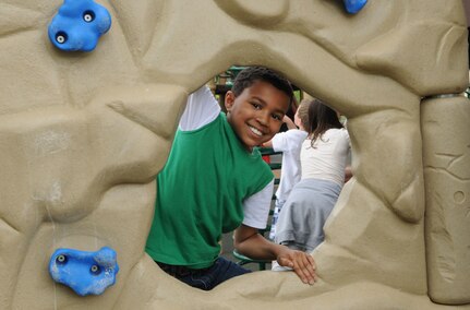 Milo Williams climbs on one of the many playground obstacles at the new Randolph Youth Center playground April 8, 2010. (U.S. Air Force Photo by Don Lindsey)