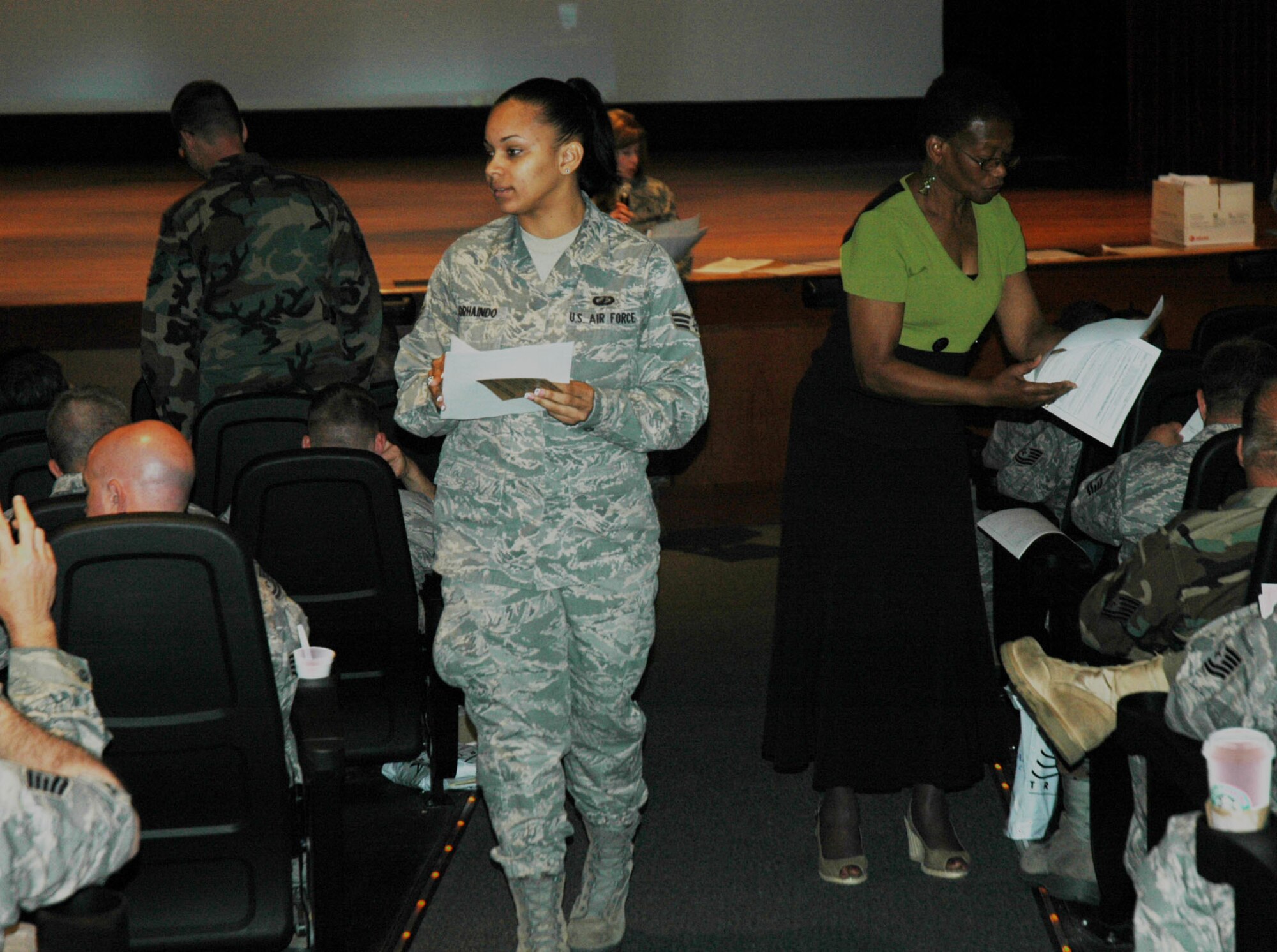 Senior Airman Allancia Sorhaido and civilian Chris Williams 315th Airlift Wing, Charleston Air Force Base S.C. pass out finance forms for more than 250 reservists. Members of the 315th AW were activated to support operations in Afghanistan. (U.S. Air Force photo/2nd Lt Joe Simms