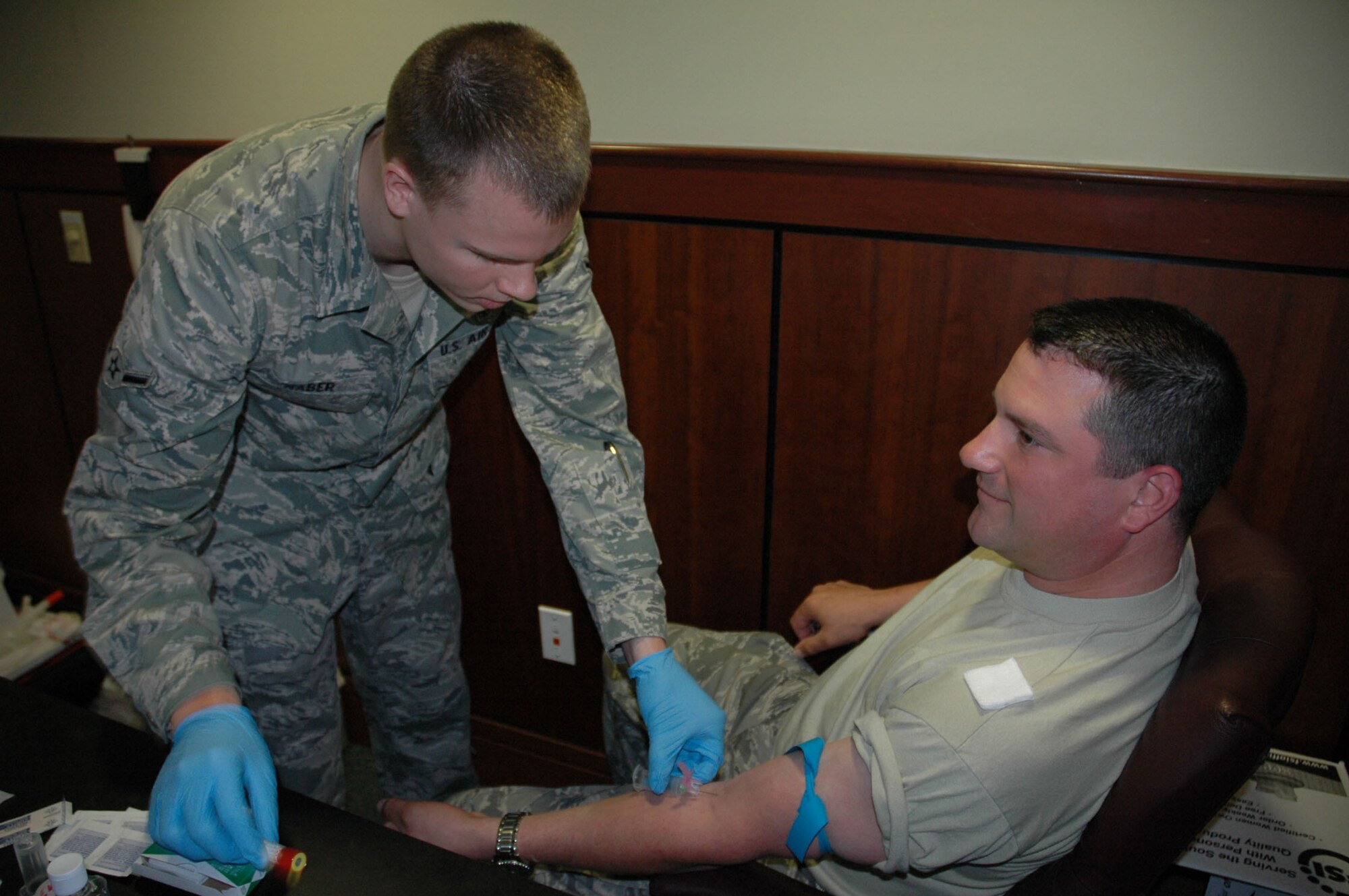 Airman Jacob Naber, 315th Airlift Wing Charleston Air Force Base S.C. preps Staff Sergeant James Rice also from the 315th AW before drawing blood. Sergeant Rice from the 315th AW maintenance squadron was activated in support of Operation Enduring Freedom. (U.S. Air Force photo/2nd Lt Joe Simms)