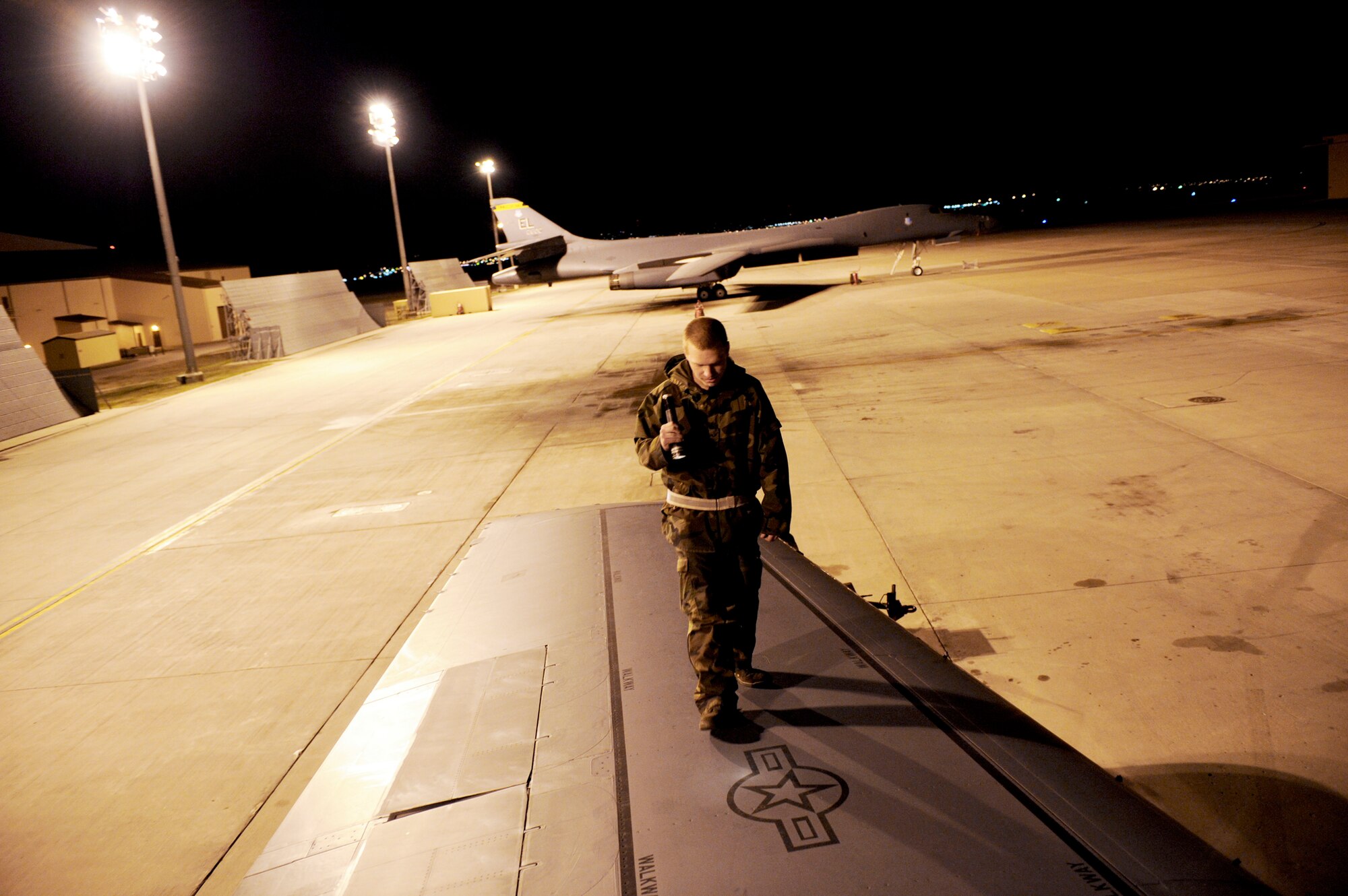 Senior Airman Scott Foust takes a closer look at a B-1B Lancer wing March 31, 2010, at Ellsworth Air Force Base, S.D. Airman Foust is a crew chief with the 28th Aircraft Maintenance Squadron (U.S. Air Force photo/Airman 1st Class Corey Hook)