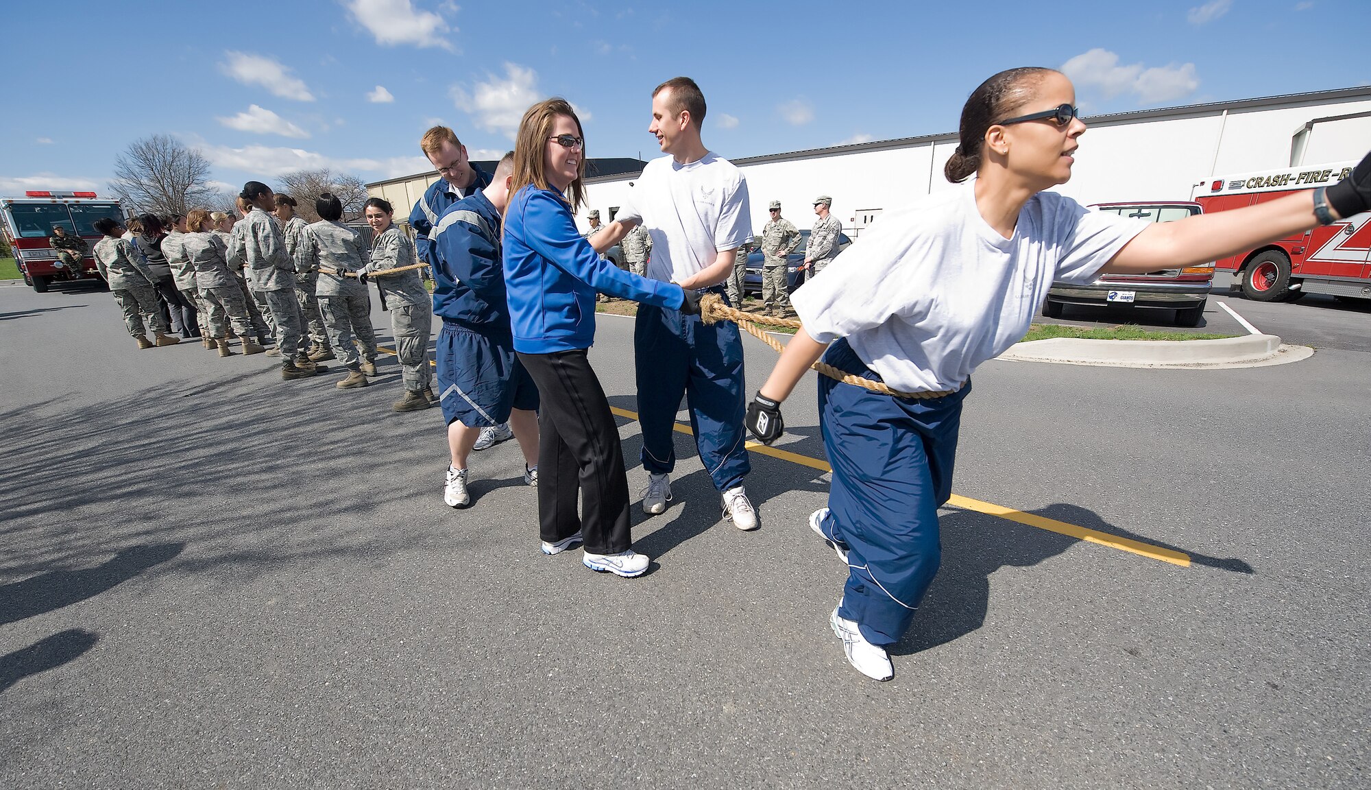 Military members prepare to pull a 3,000 pound fire truck in support of Women?s History Month March 31.  Nearly 30 participants worked together to pull the fire truck 100 yards in a little over a minute.   (U.S. Air Force Photo / Brianne Zimny)