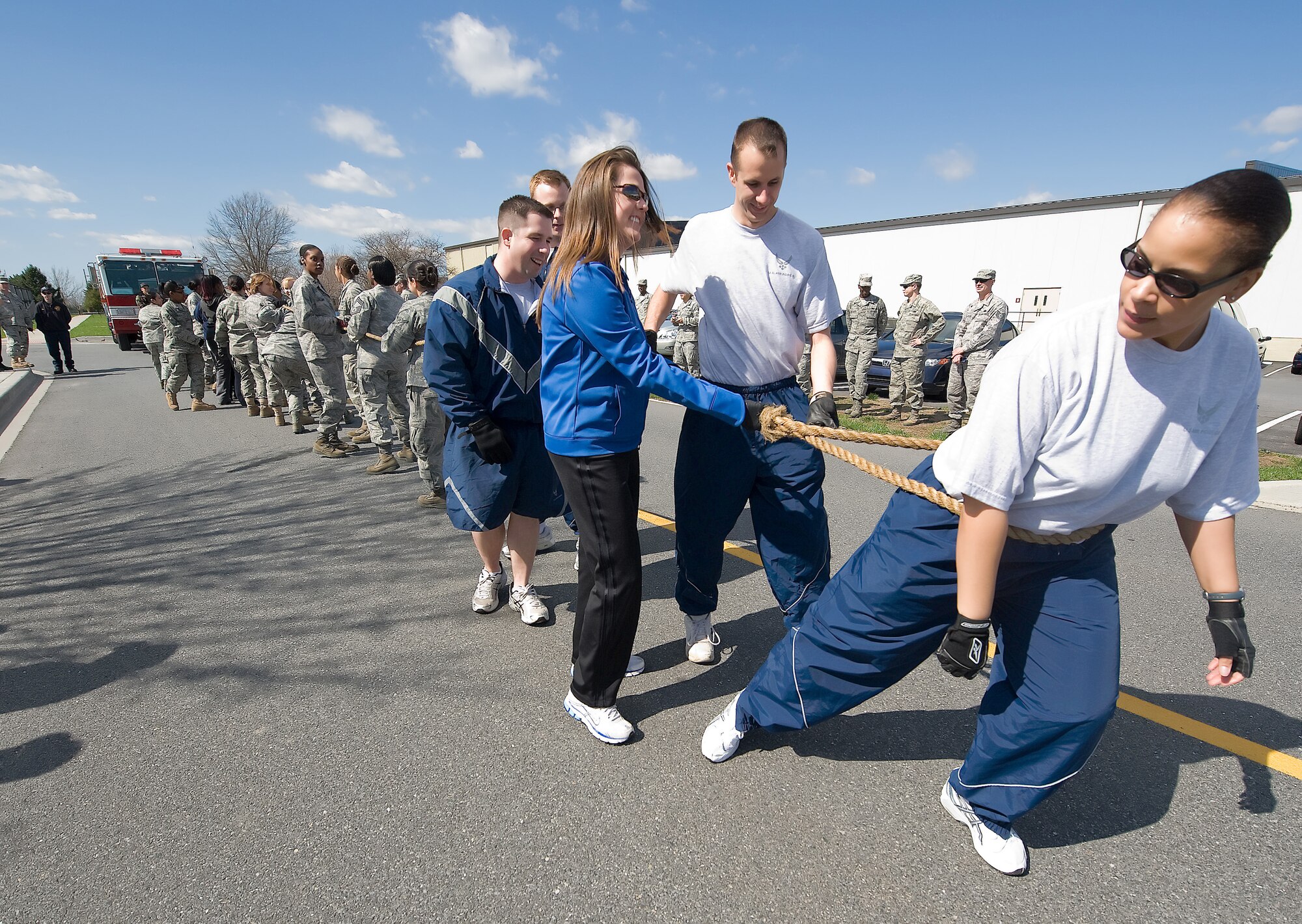 Military members prepare to pull a 3,000 pound fire truck in support of Women?s History Month March 31.  Nearly 30 participants worked together to pull the fire truck 100 yards in a little over a minute.   (U.S. Air Force Photo / Brianne Zimny)