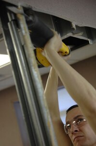 U.S. Air Force Senior Airman Morgan Jarrett saws through a wall beam during a renovation project at Joint Base Charleston, S.C., April 1, 2010. As a structural journeyman, Airman Jarrett manages, constructs, repairs and modifies structural systems and wooden, masonry, metal and concrete buildings, in additional to fabricating and repairing components of buildings, utility systems and real property equipment. Airman Jarrett is  with the 628th Civil Engineer Squadron. (U.S. Air Force photo/Senior Airman Timothy Taylor)