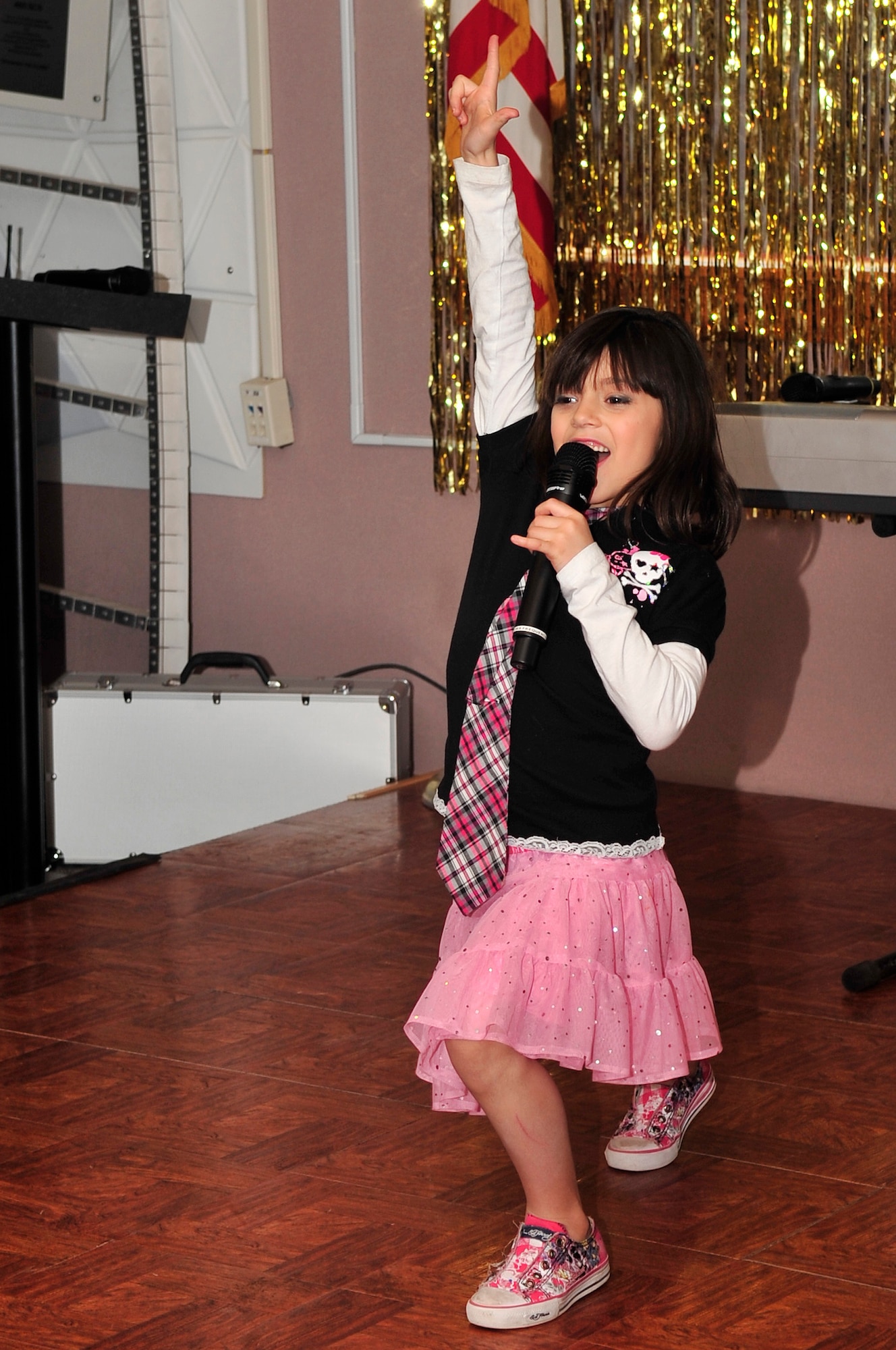 Seven-year-old Eliana Morales steals the spotlight during a performance of “Eye of the Tiger” at Buckley’s “You Got Talent!” competition finale March 30. “You Got Talent!” supports the Year of the Air Force Family and is a popular program that provides an opportunity for families to showcase their creative abilities through the performing arts. (U.S. Air Force photo by Airman 1st Class Manisha Vasquez)