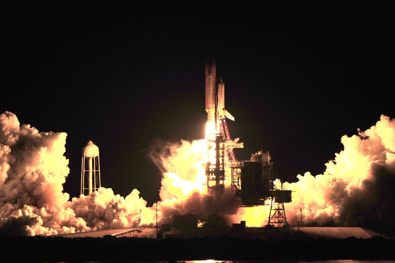 KENNEDY SPACE CENTER, Fla. - NASA's Space Shuttle Discovery successfully launched, lighting up the morning sky, from  Kennedy Space Center, located 11 miles north of Patrick Air Force Base in Cocoa Beach, Fla. The rescue Reservists from the 920th Rescue Wing, located on Patrick AFB, were part of several crews on HH-60G Pave Hawk helicopters and HC-130 P/N Hercules planes to make sure, if there was an emergency, they were onhand to provide live-saving measures. Each aircraft is set up llike a flying ambulance with pararescuemen and flight doctors on board. (U.S. Air Force photo/Master. Sgt Rob Grande)