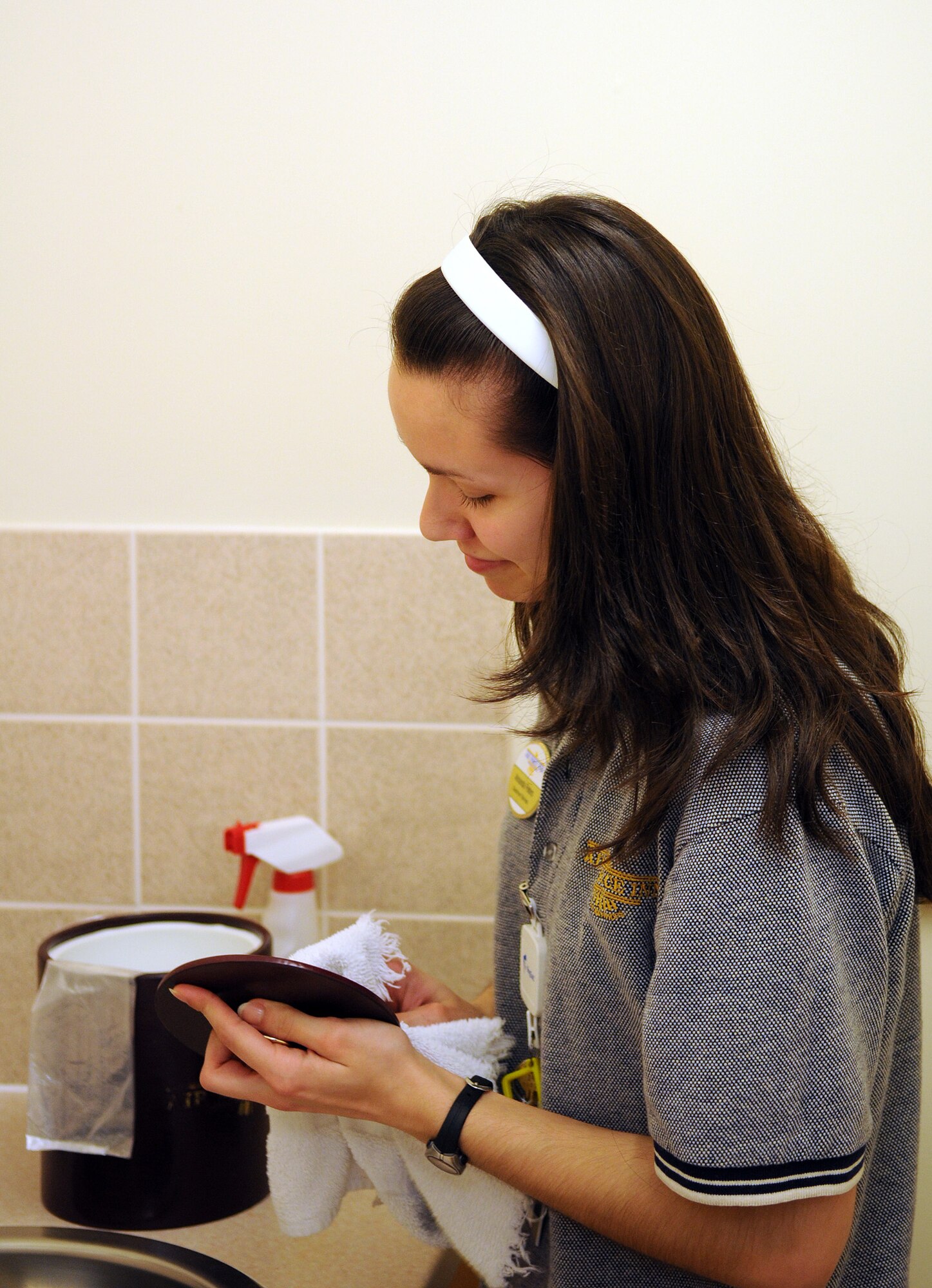 RAF MILDENHALL, England -- Amanda Peters, Gateway Inn housekeeper, tidies up the kitchenette area of a guest room at the lodging facility here April 6. Ms. Peters is one of 44 housekeeping personnel who maintain the 318 lodging rooms to Air Force standards. (U.S. Air Force photo/Staff Sgt. Thomas Trower)